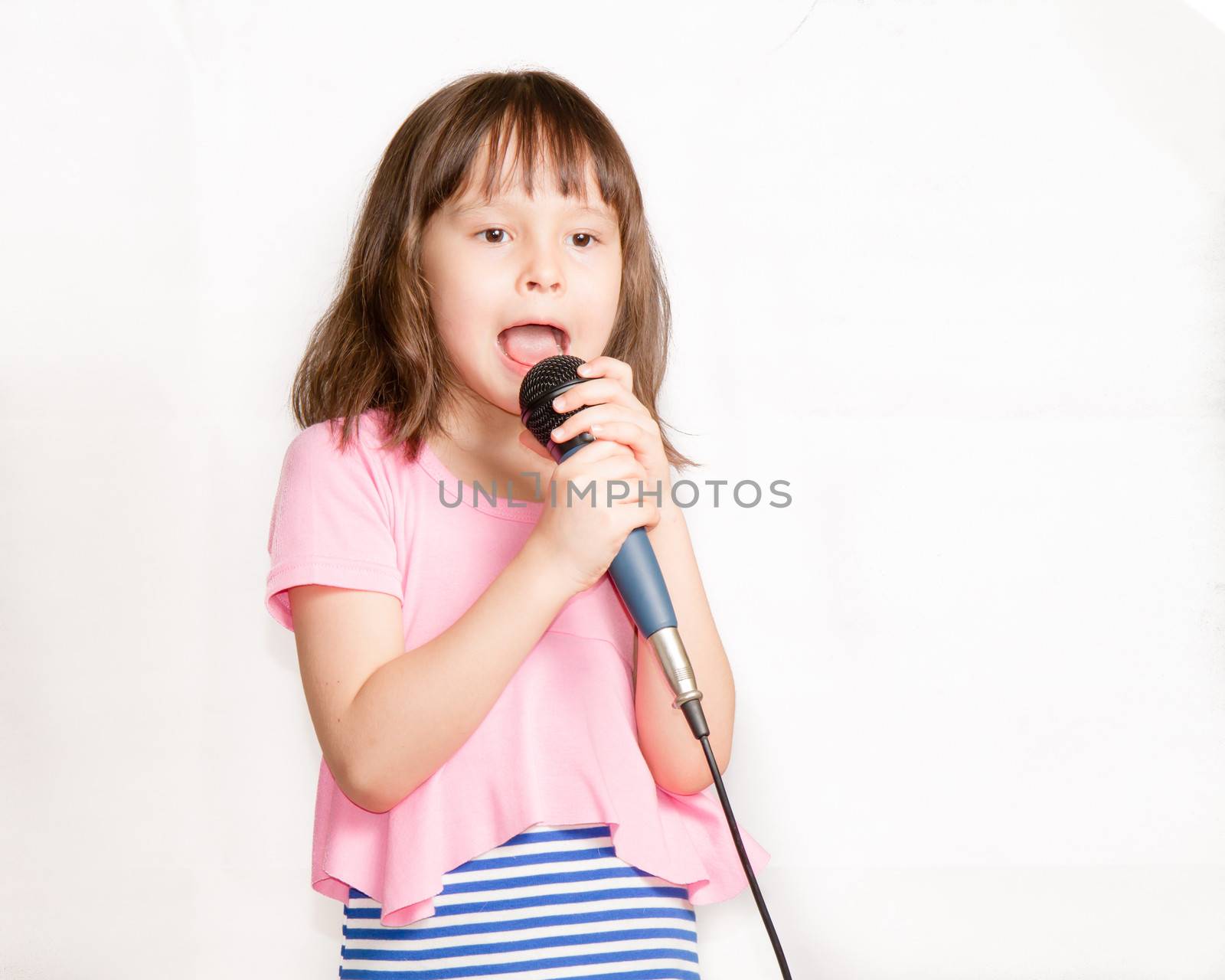Asian child singing into a microphone by imagesbykenny