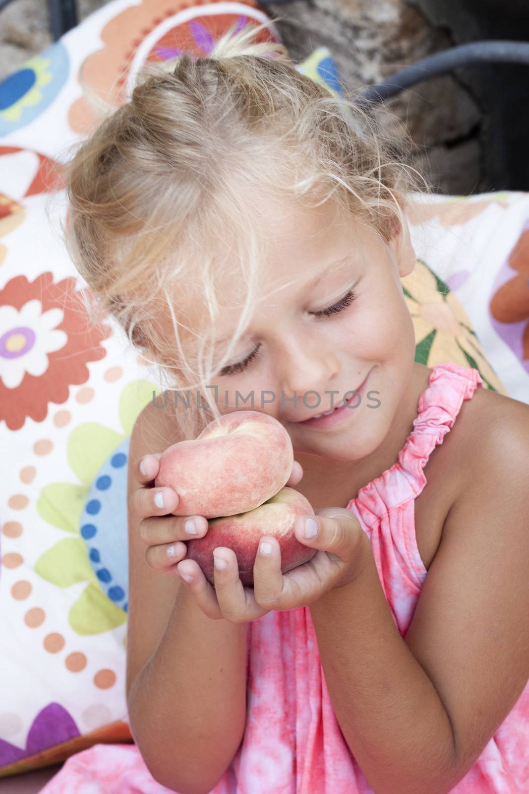 Girl with flat shaped peaches called peento