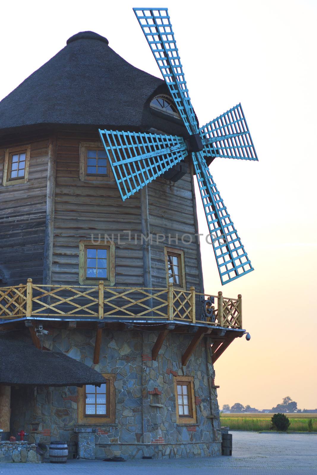 Old wooden windmill on the road in the village