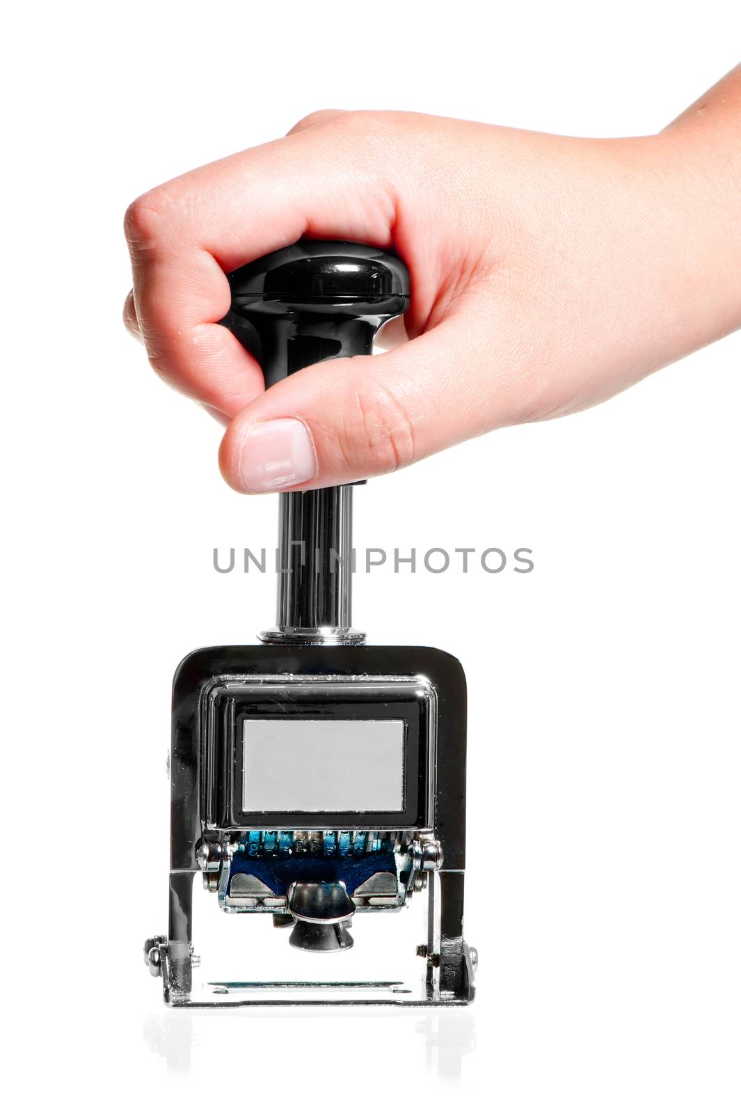 hand holding a metal seal with the date the handle on a white background