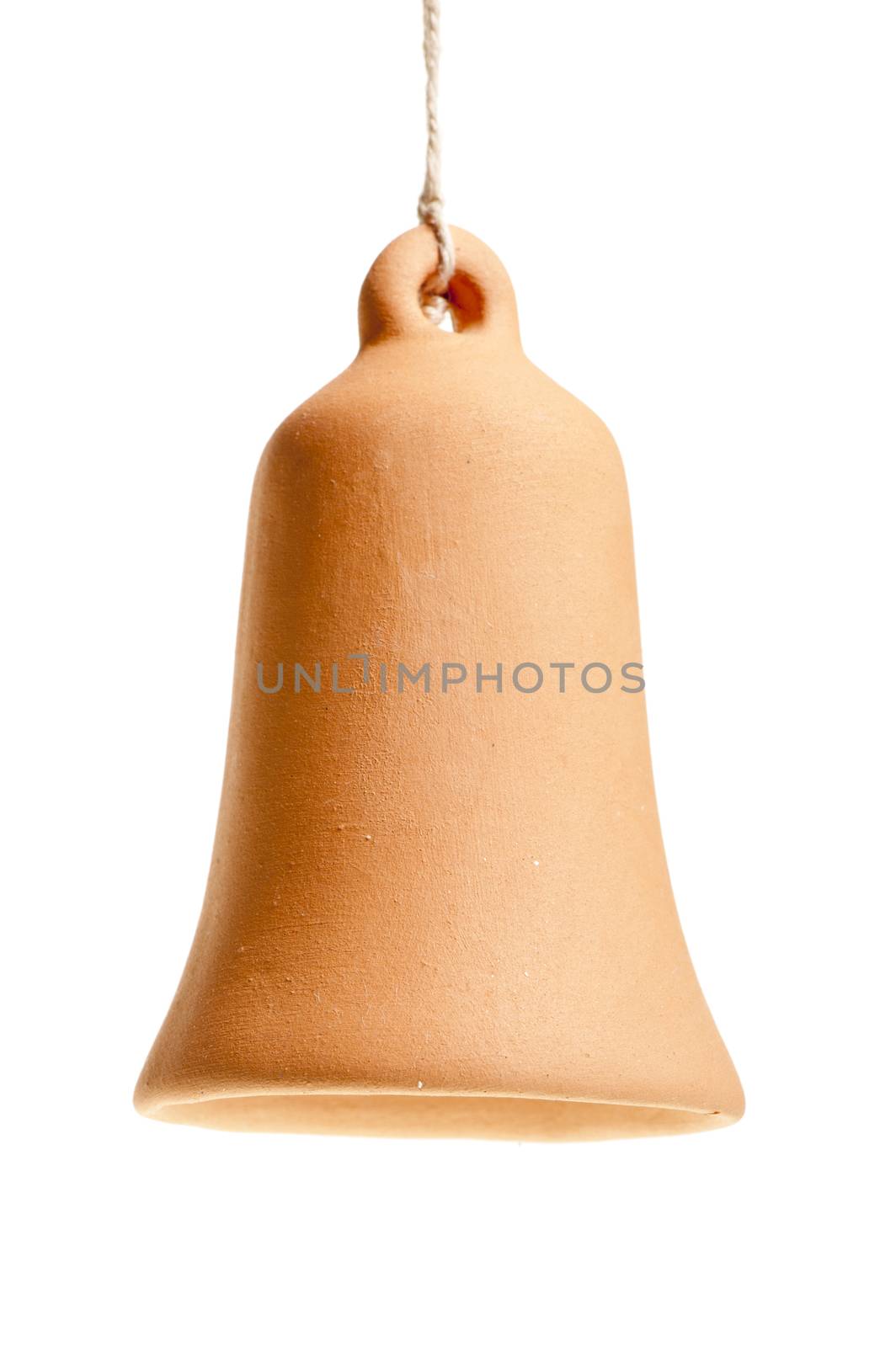handmade clay bell hanging from a rope on a white background