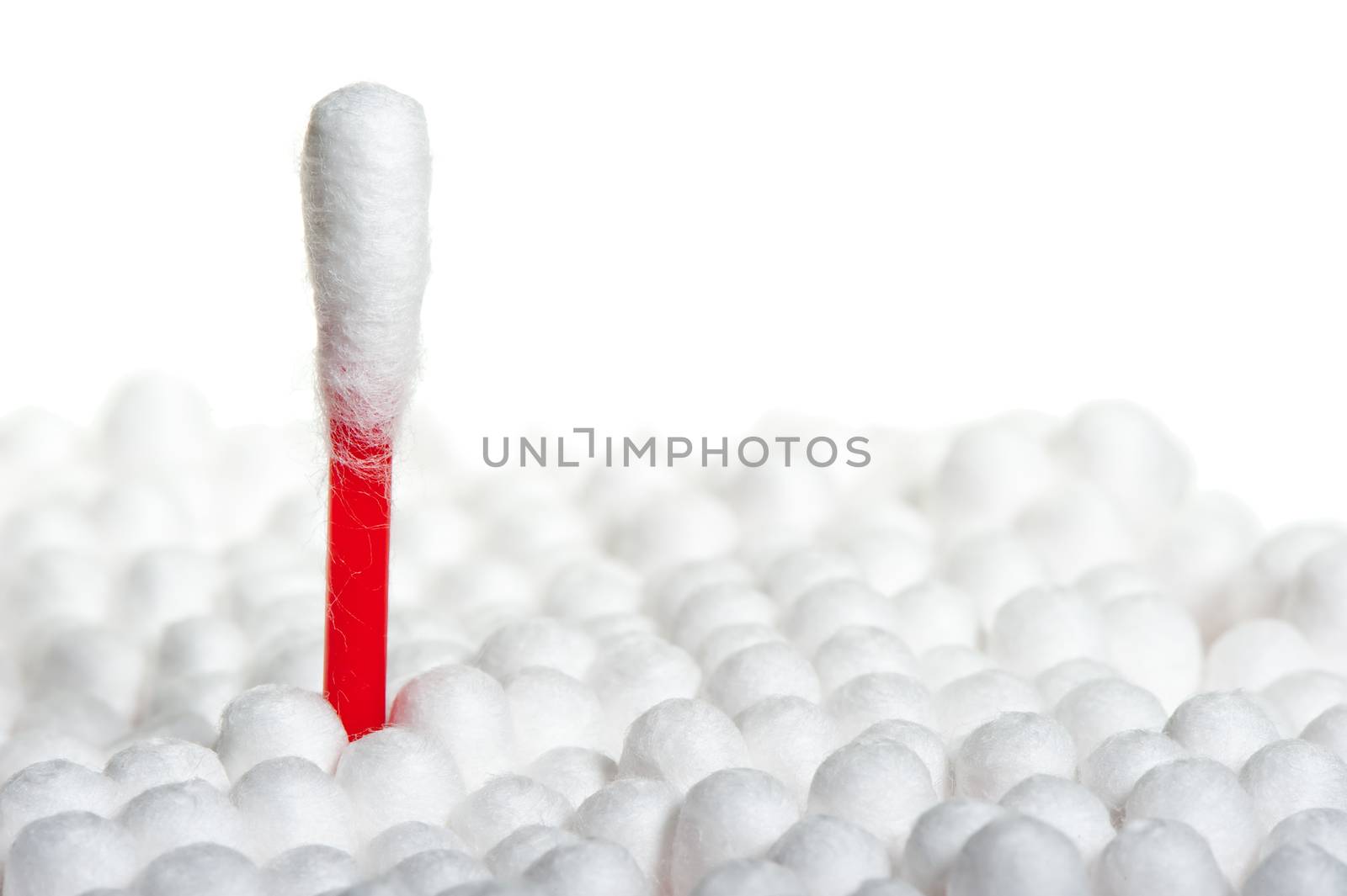 Q-tip stands out from the crowd of other on a white background