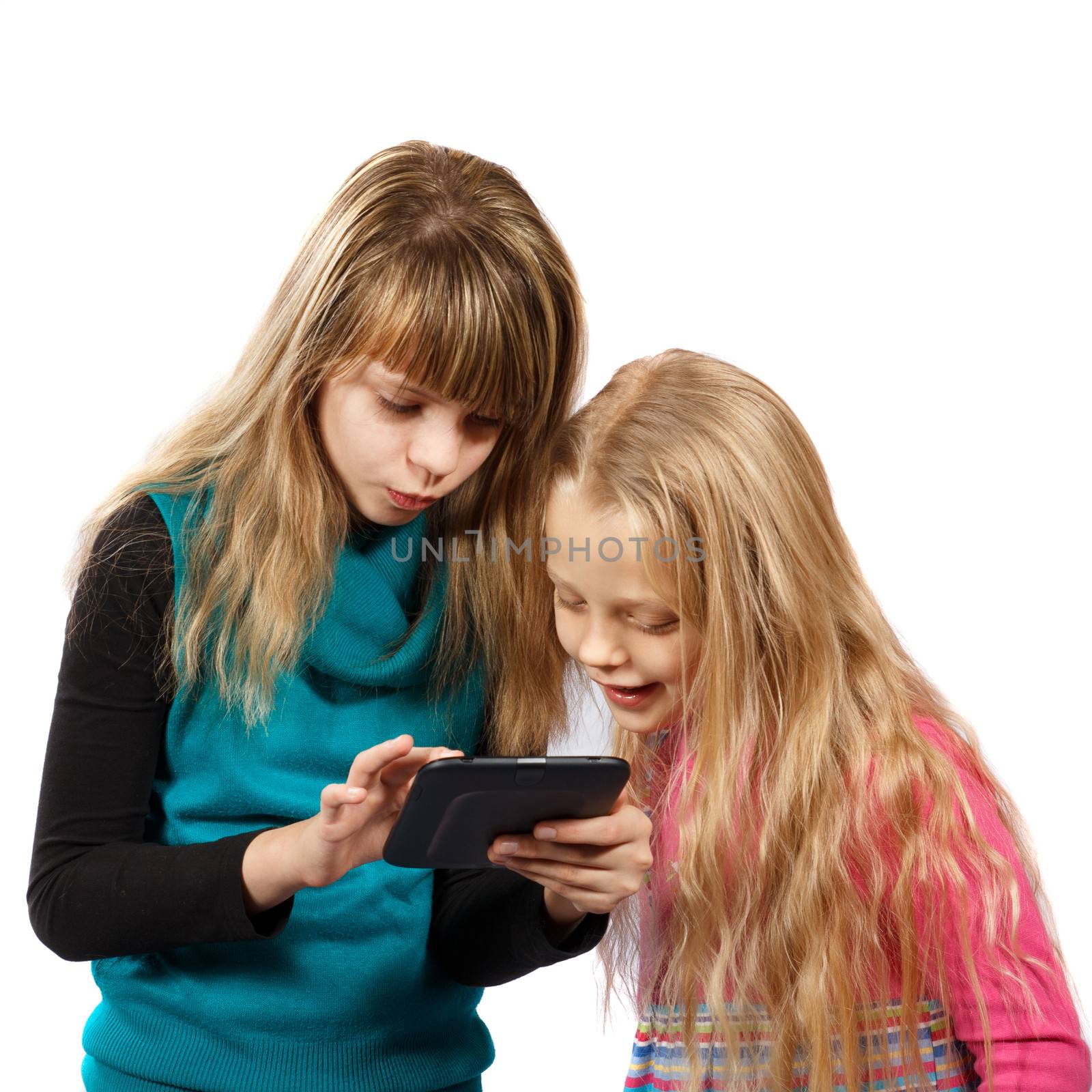 two girls playing with tablet pc by AigarsR