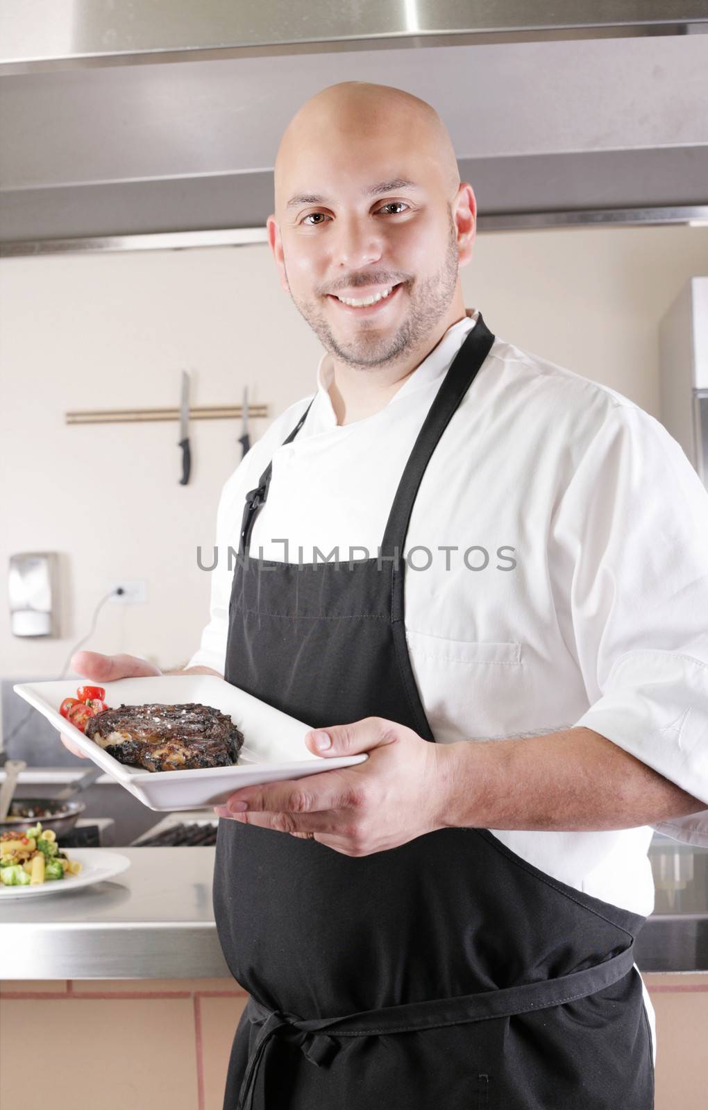 Chef presenting a juicy steak in the kitchen
