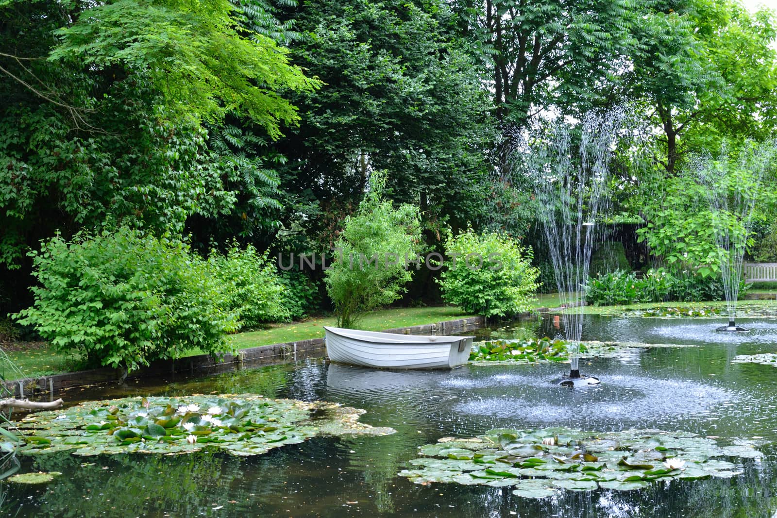 pond with boat and fountain