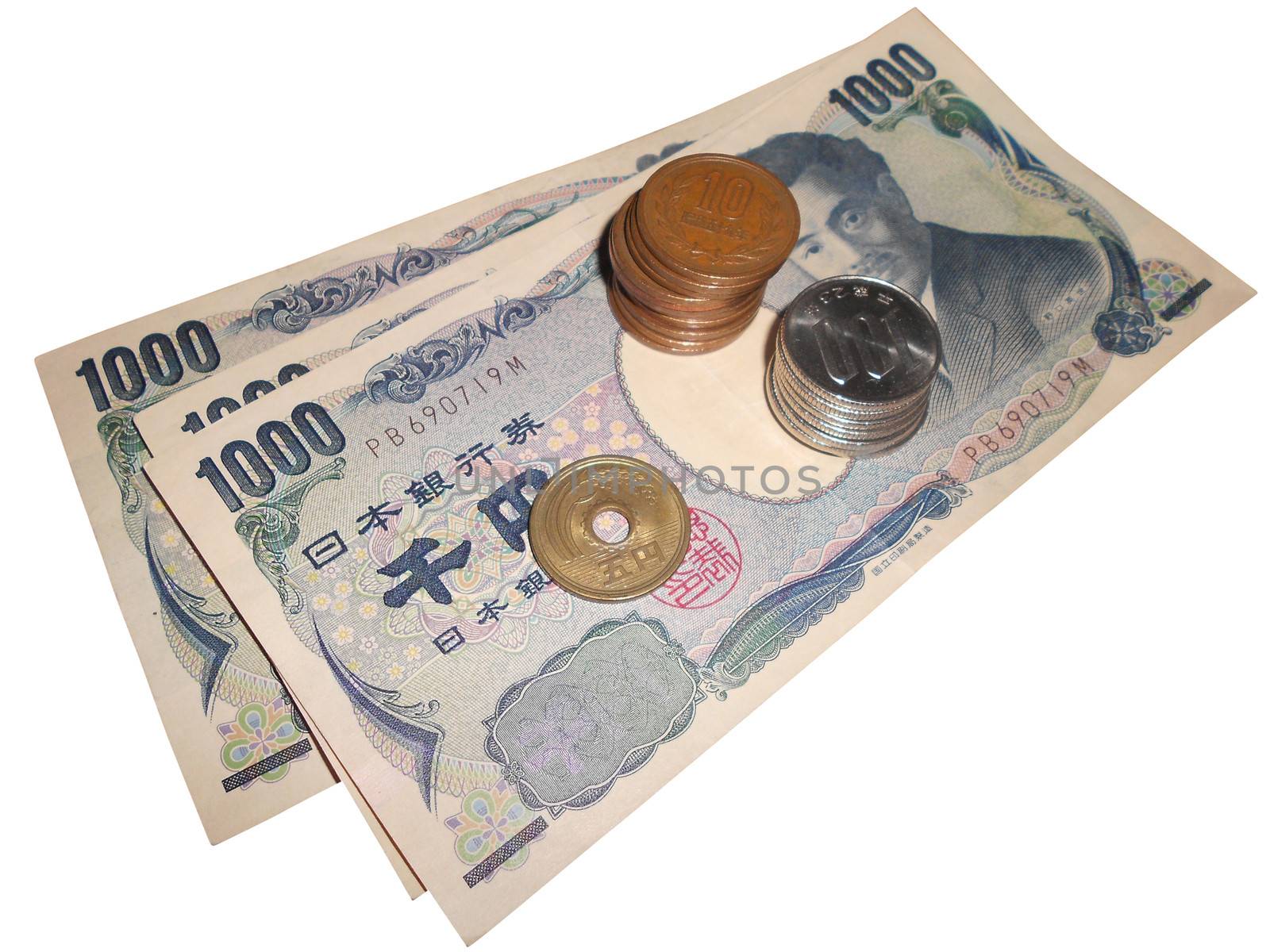 Japanese currency bills and coins stacked over white with clipping path.