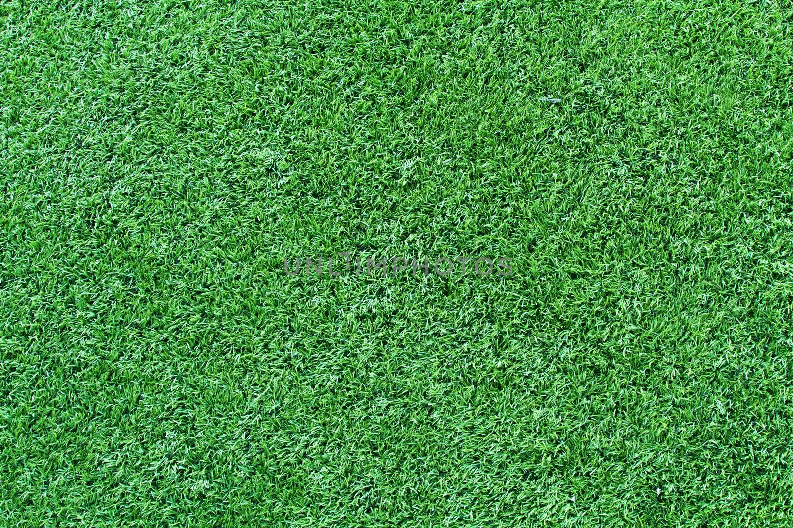 Green artificial grass soccer field for background
