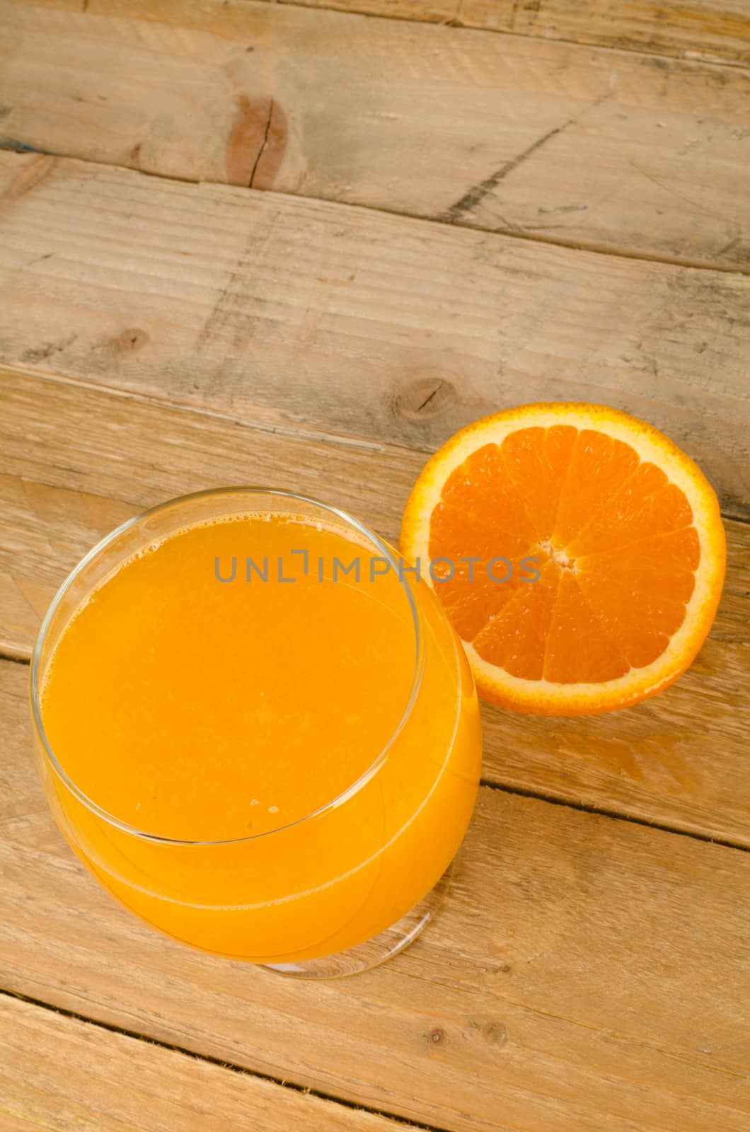 Orange juice against an old wood background