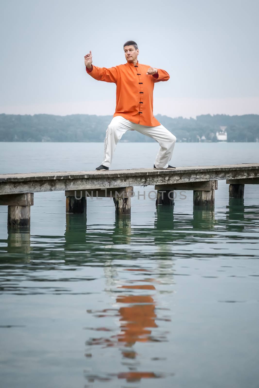 A man doing Qi-Gong in the early morning at the lake Starnberg