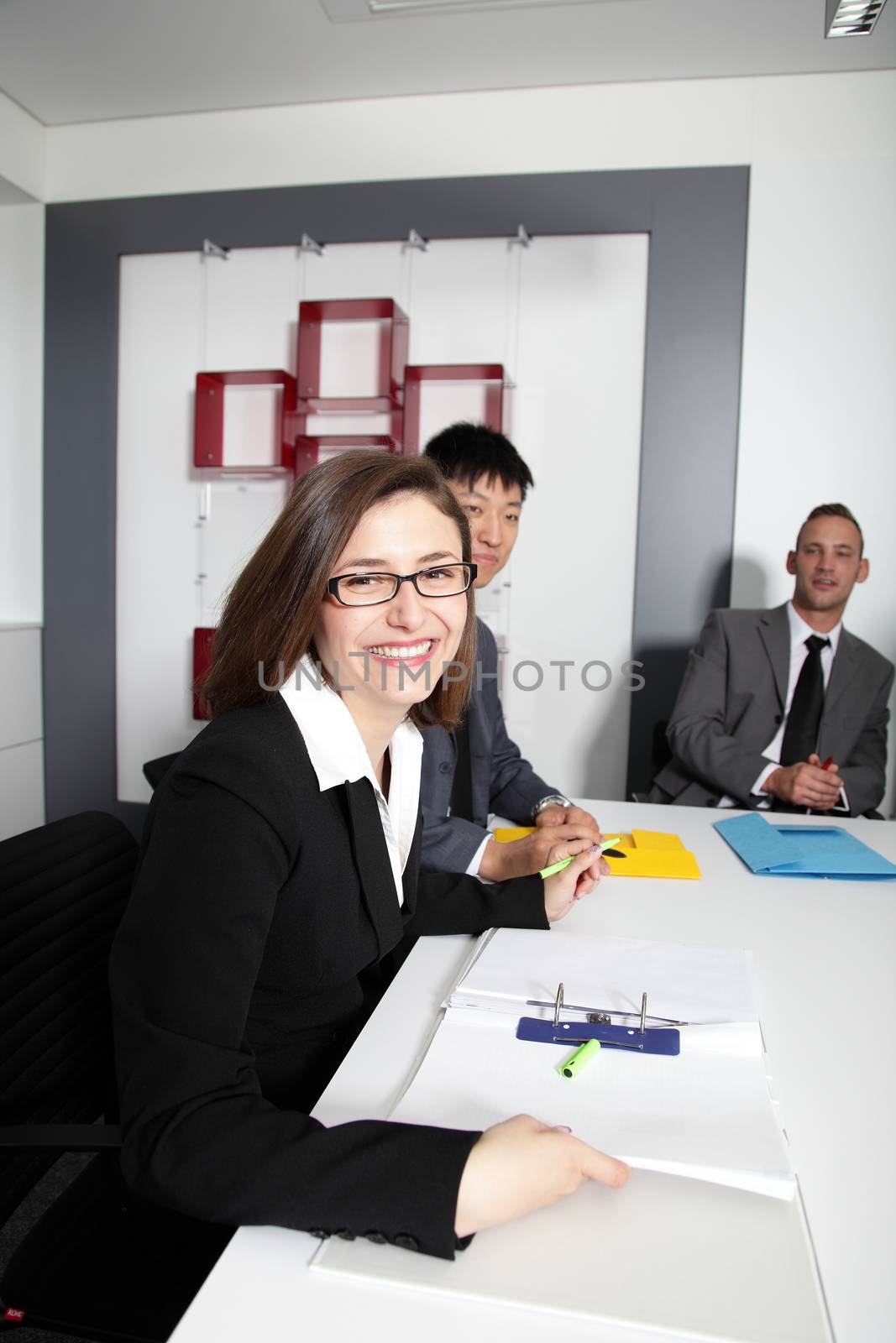 Happy businesswoman over her two colleagues at the boardroom