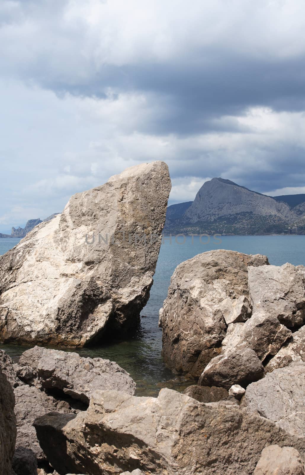 Summer landscape with big stones on shore near sea