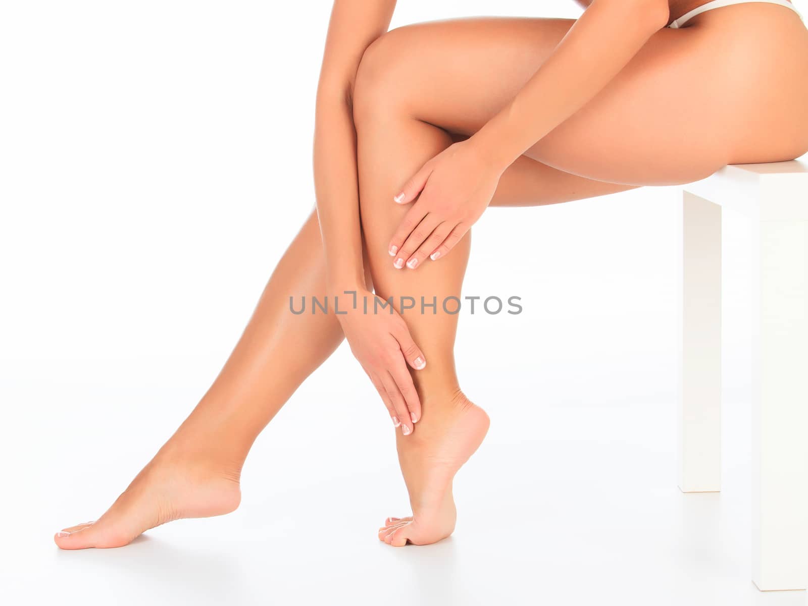 Female legs and hands, white background