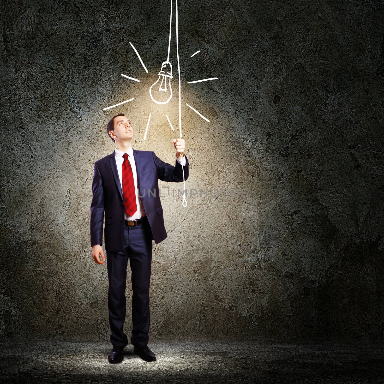 Image of businessman in black suit against dark background