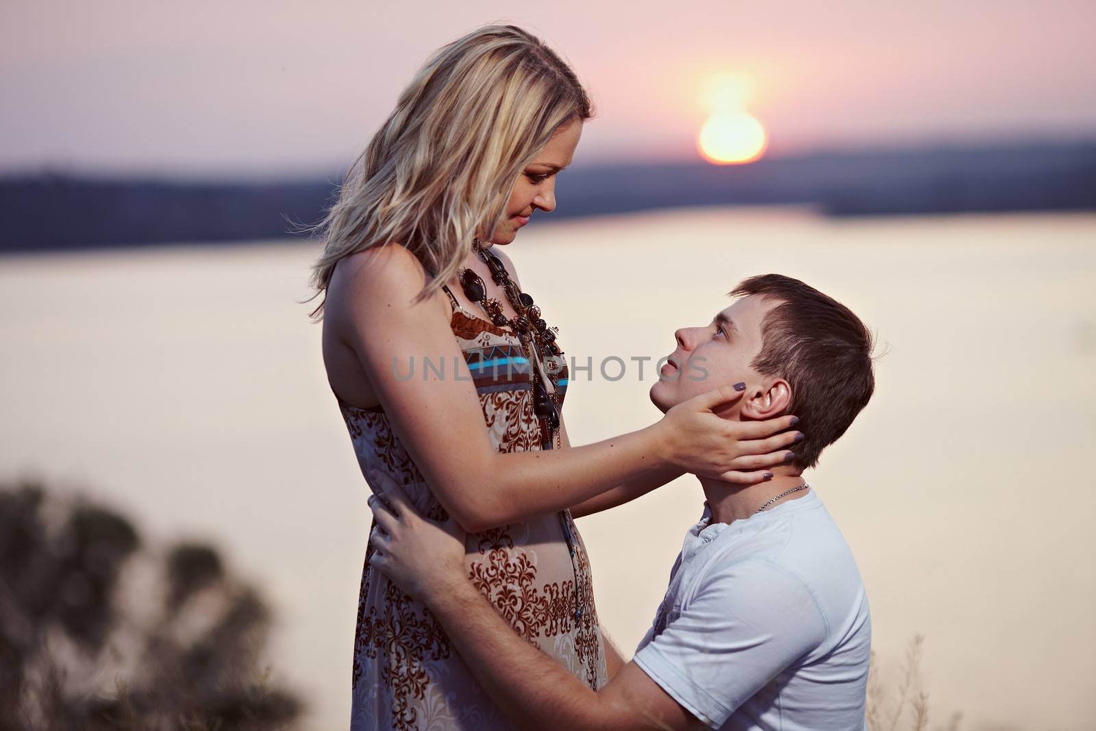 Man makes a marriage proposal at sunset