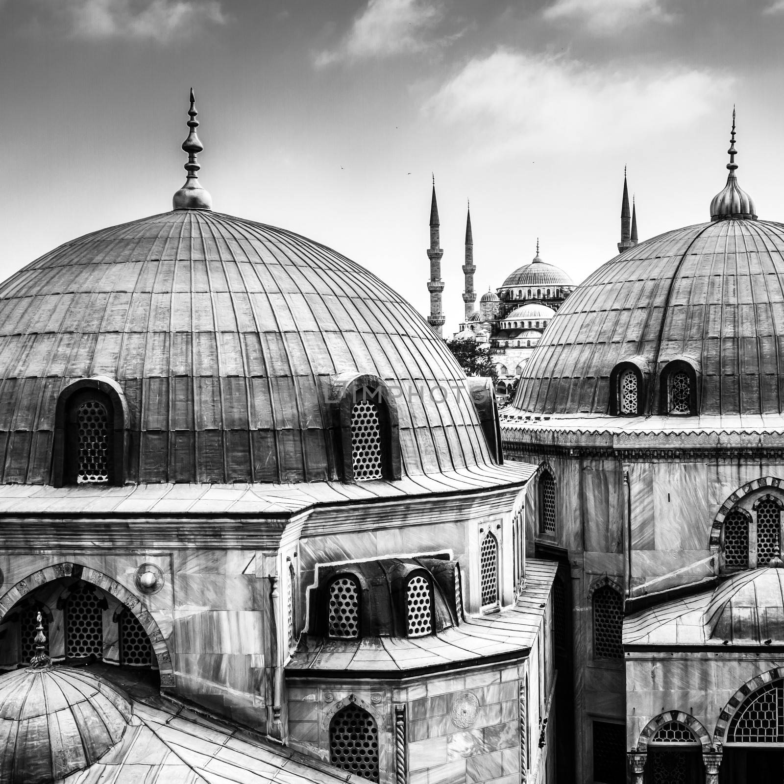 Blue Mosque or Sultan Ahmed Mosque viewed trough the window of Hagia Sophia, former Orthodox patriarchal basilica (church), later a mosque, and now a museum in Istanbul, Turkey. Black and white.