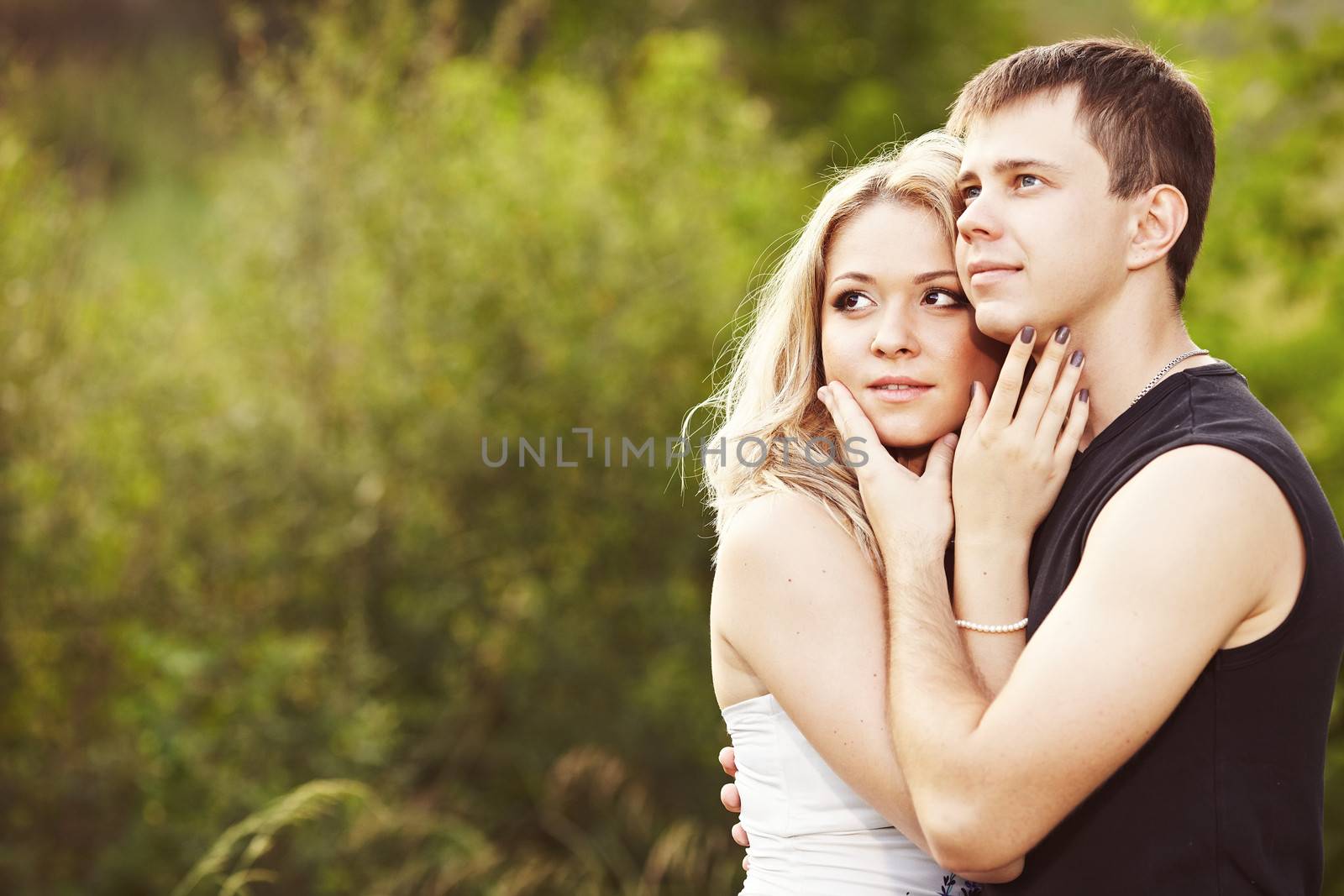 Man and woman embracing and looking into the distance