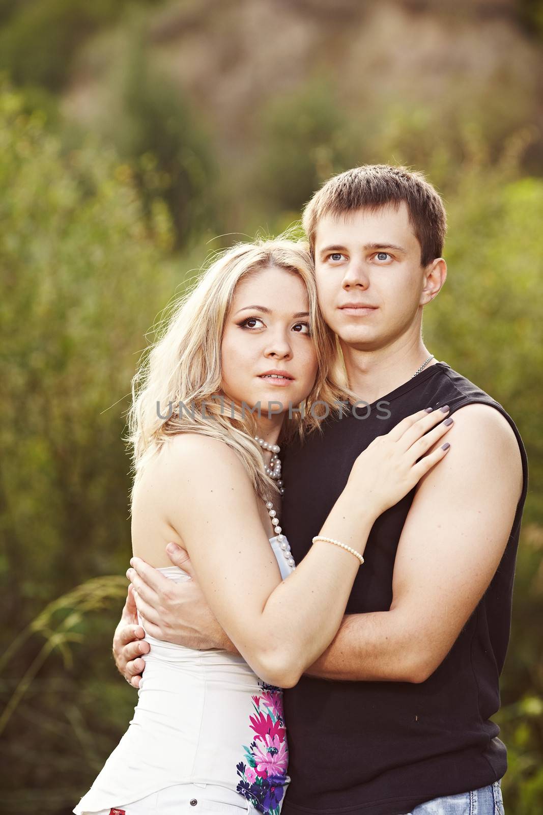 Man and woman embracing and looking into the distance