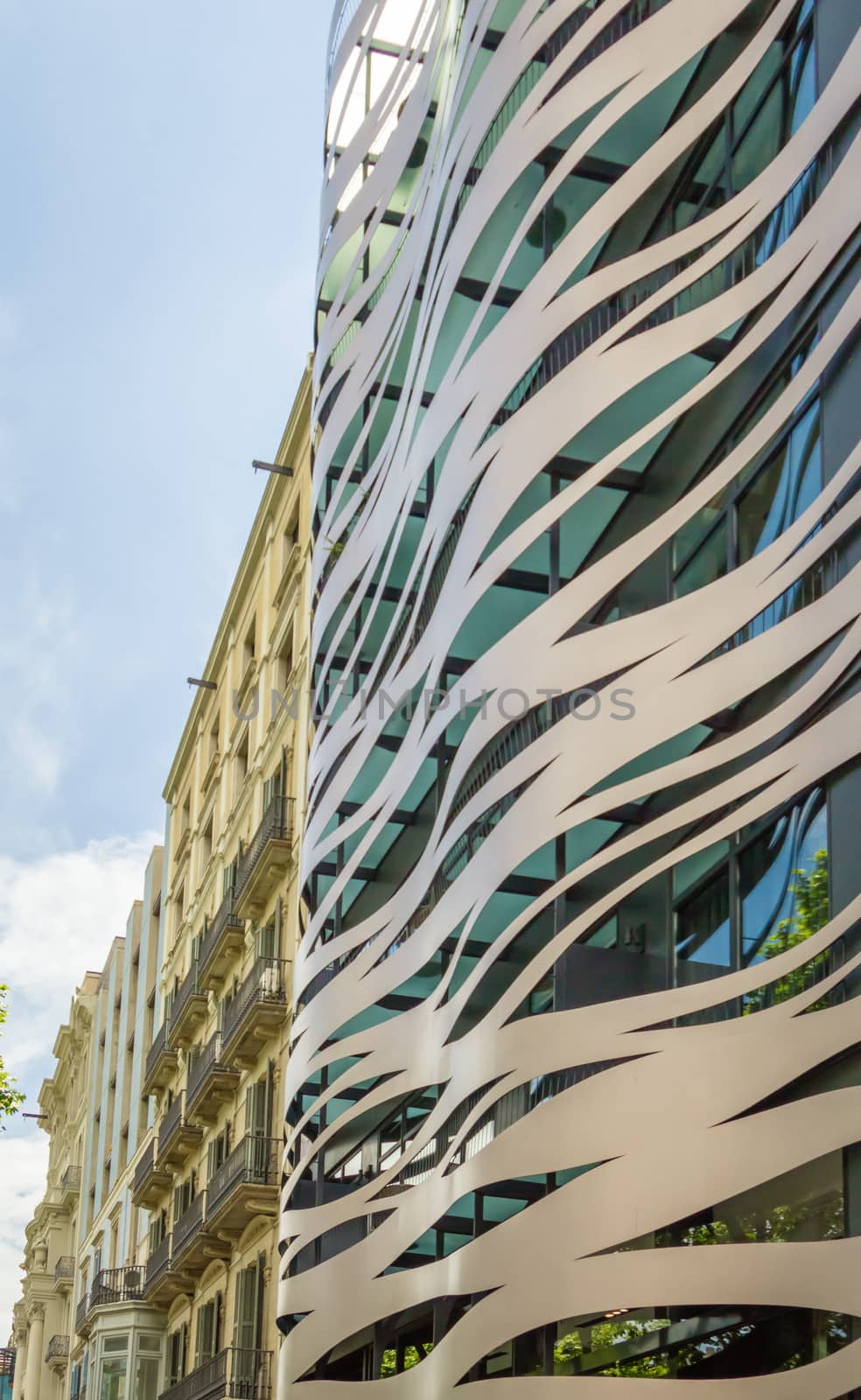 Facade of modern building, constructed with metal elements and waves forms