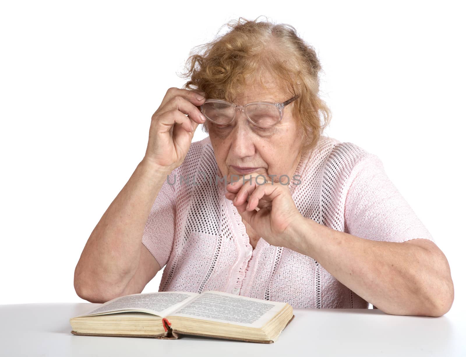 old woman in glasses reads the book on a white background