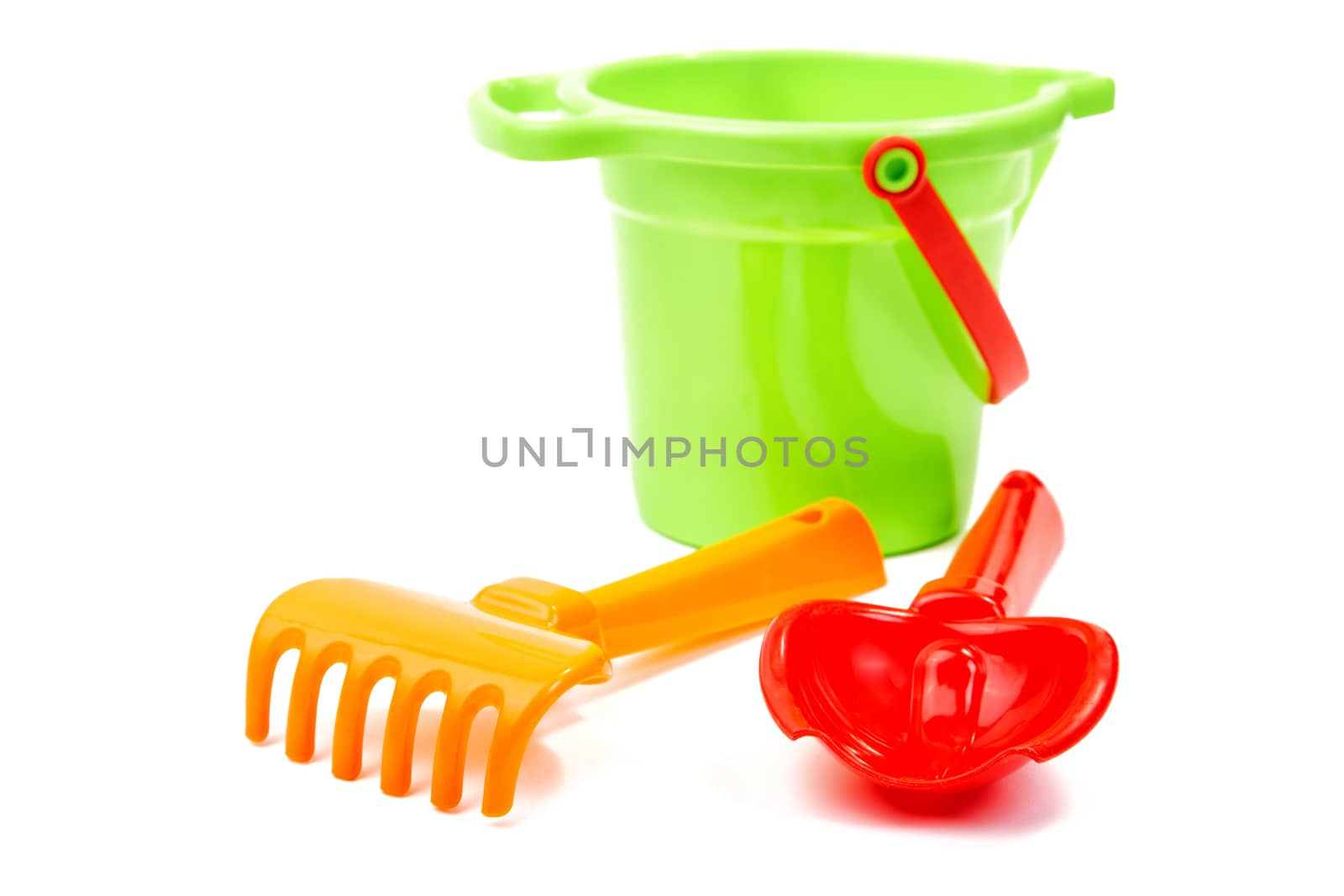 Children's toys  bucket  shovel and  rake on the white