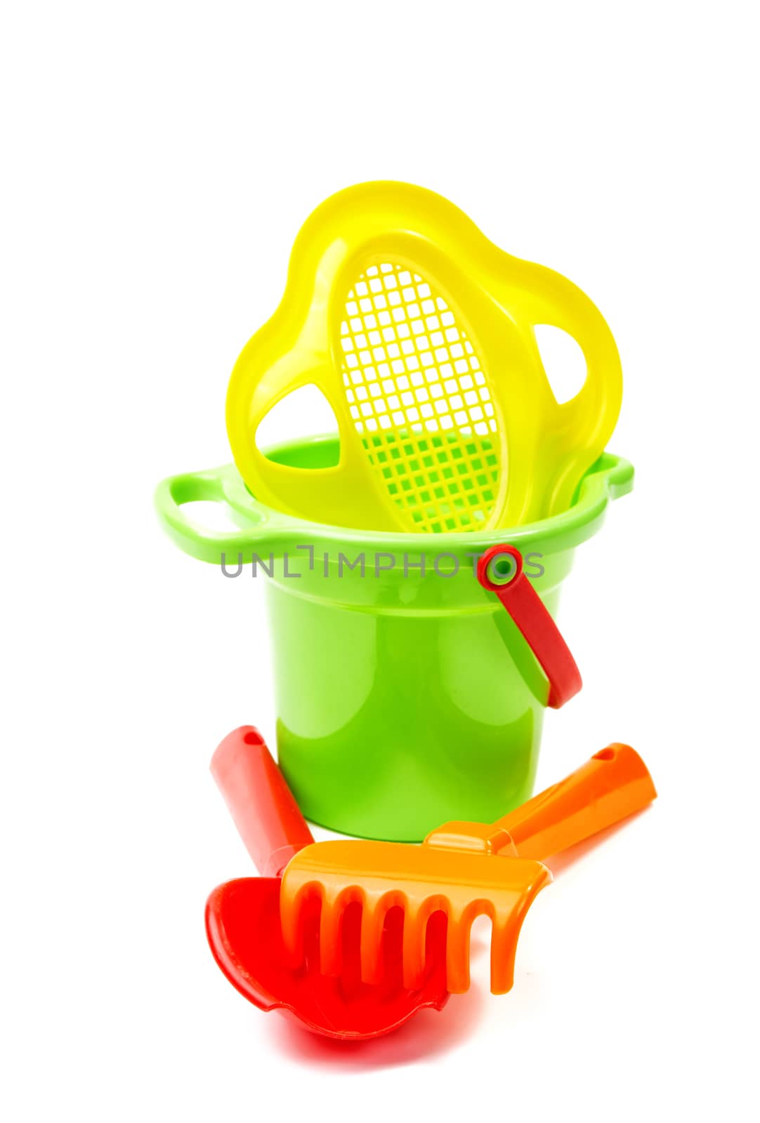 Children's toys  bucket  shovel and  rake on the white