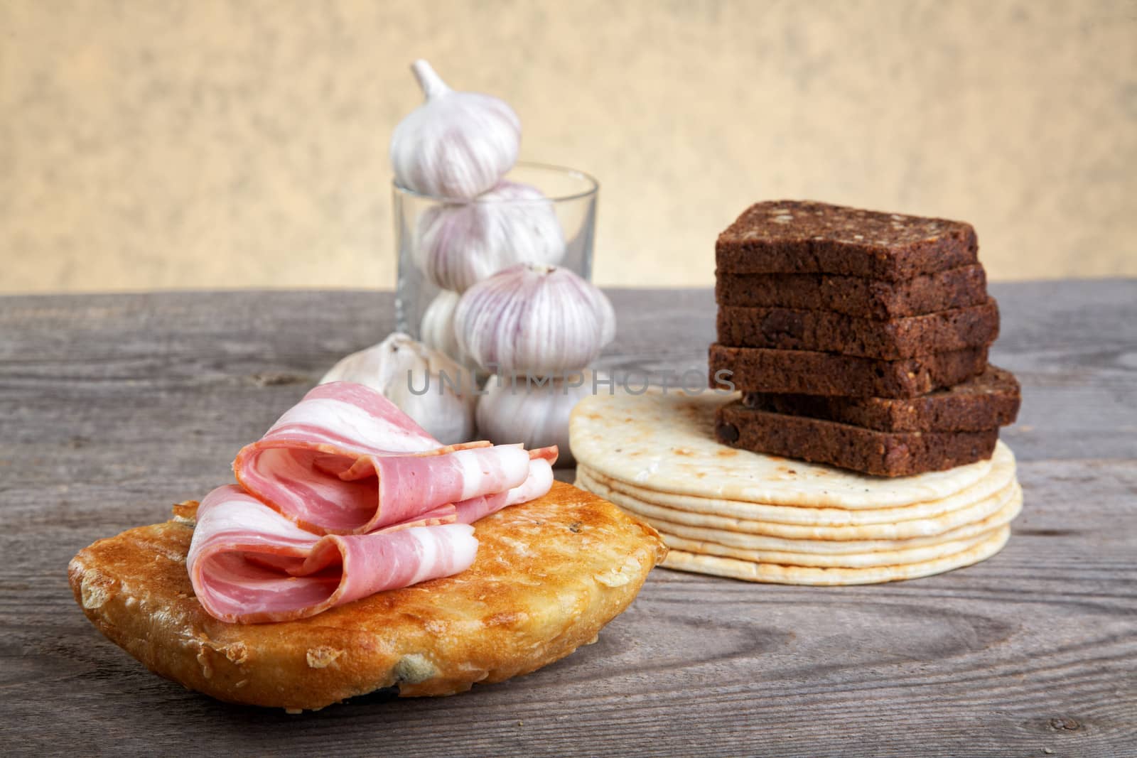 Still-life with bread slices of bacon and garlic