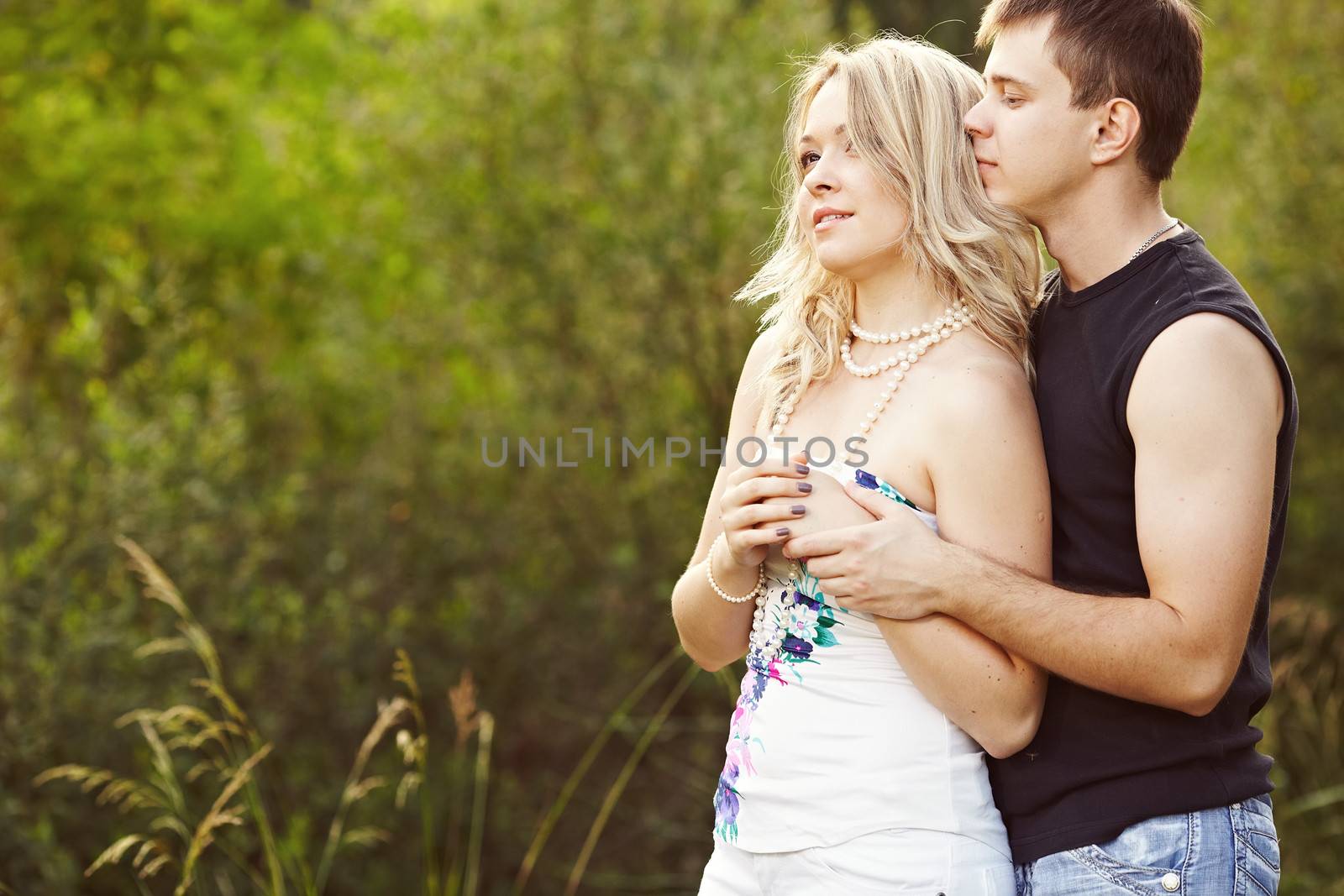 Man and woman embracing and looking into the distance