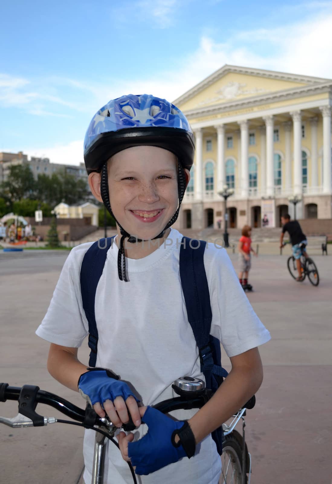 The cheerful teenager by bicycle near the Tyumen drama theater. Russia.
