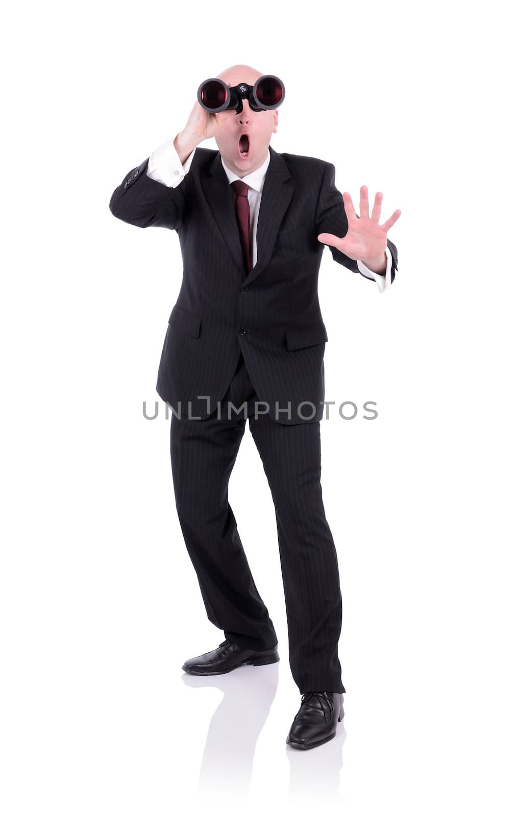 businessman looking through Binoculars with surprised face isolated on white