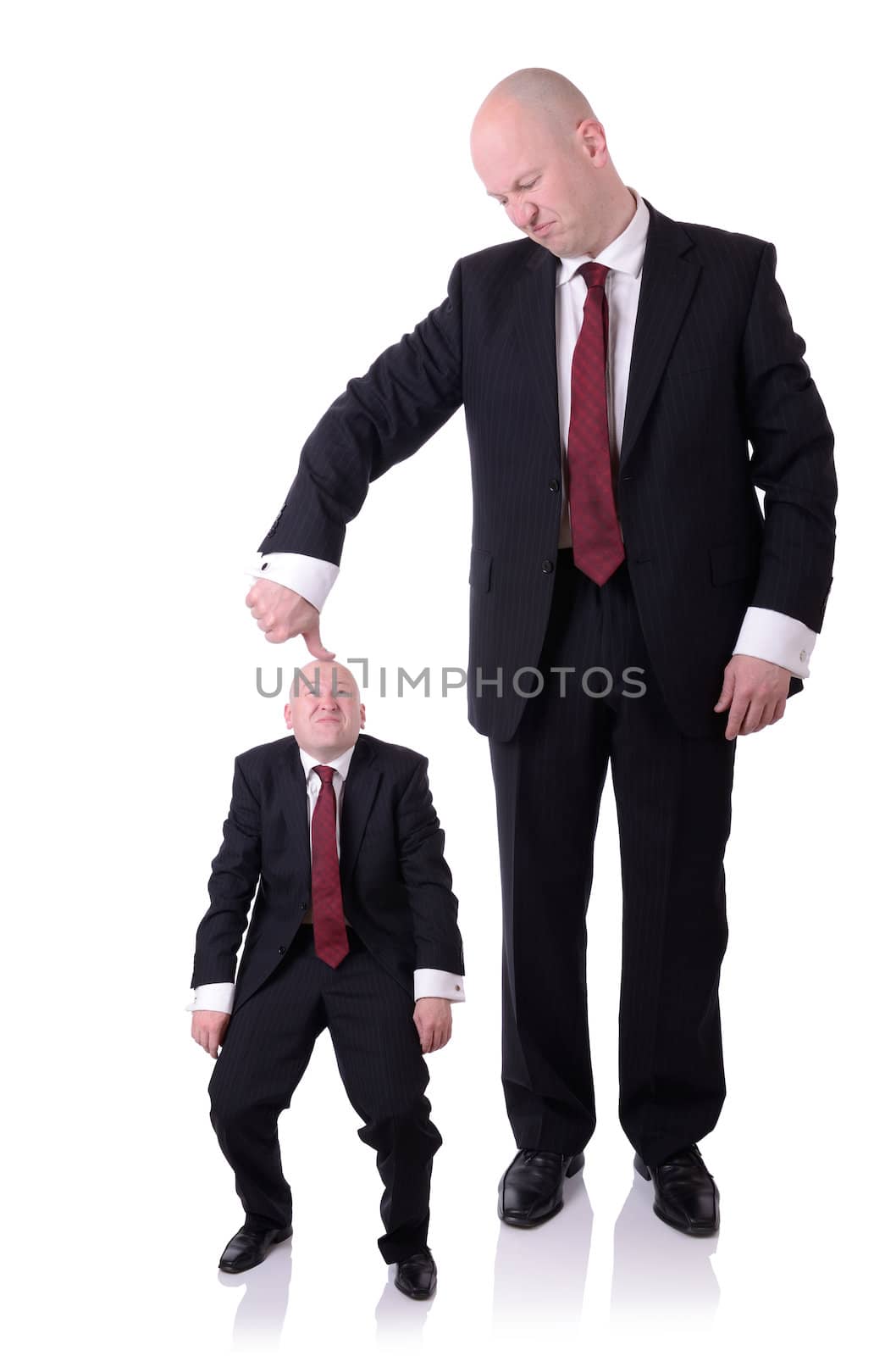 under the thumb businessman pushing down on a businessman isolated on white