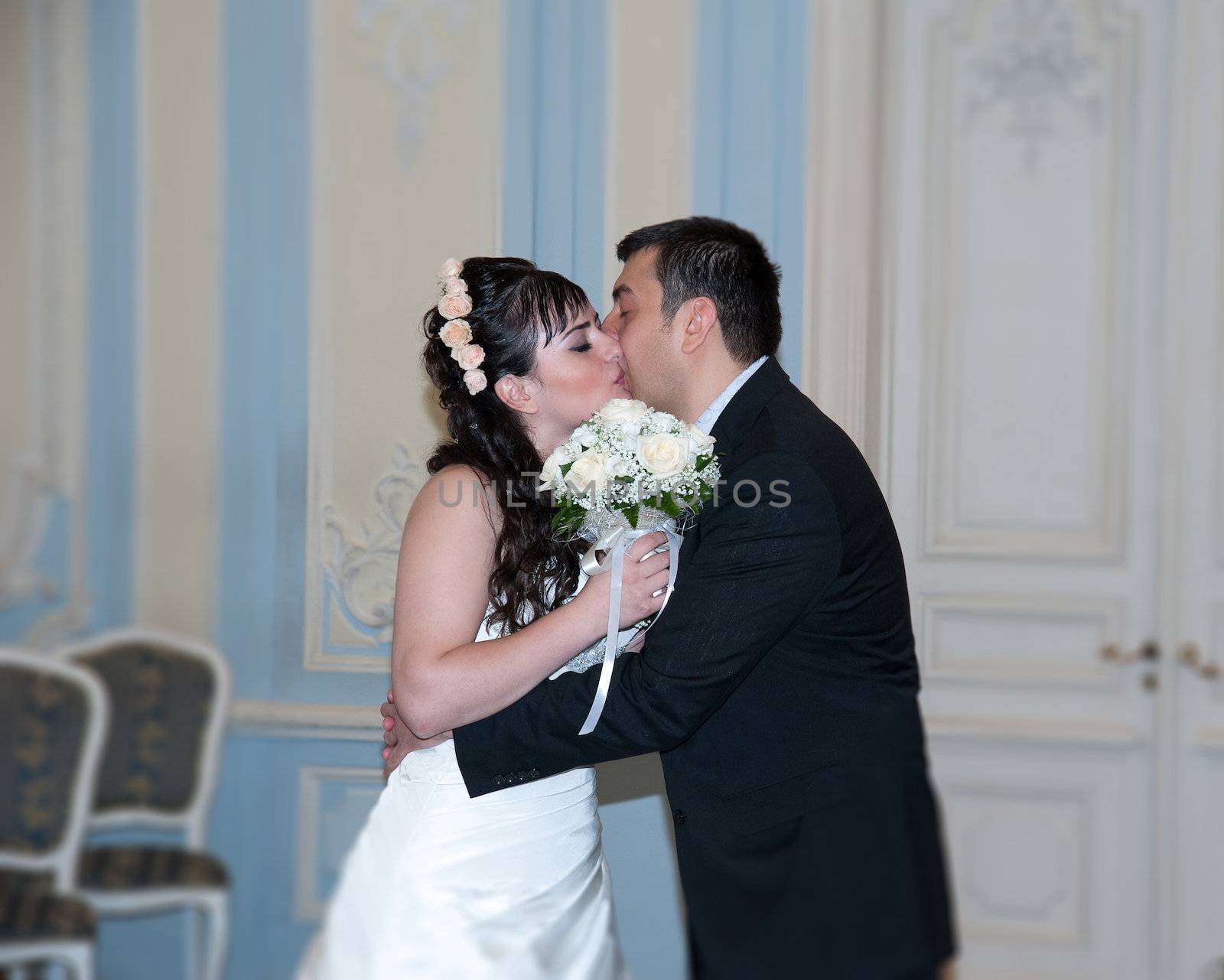 bride and groom kissing in the palace