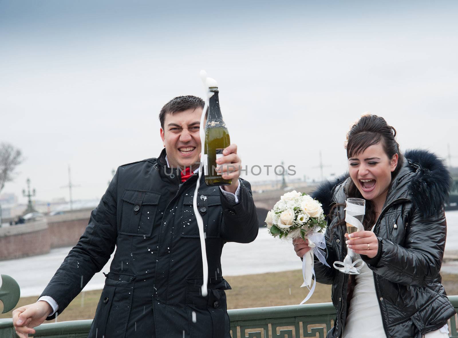 bride and groom drinking champagne by raduga21