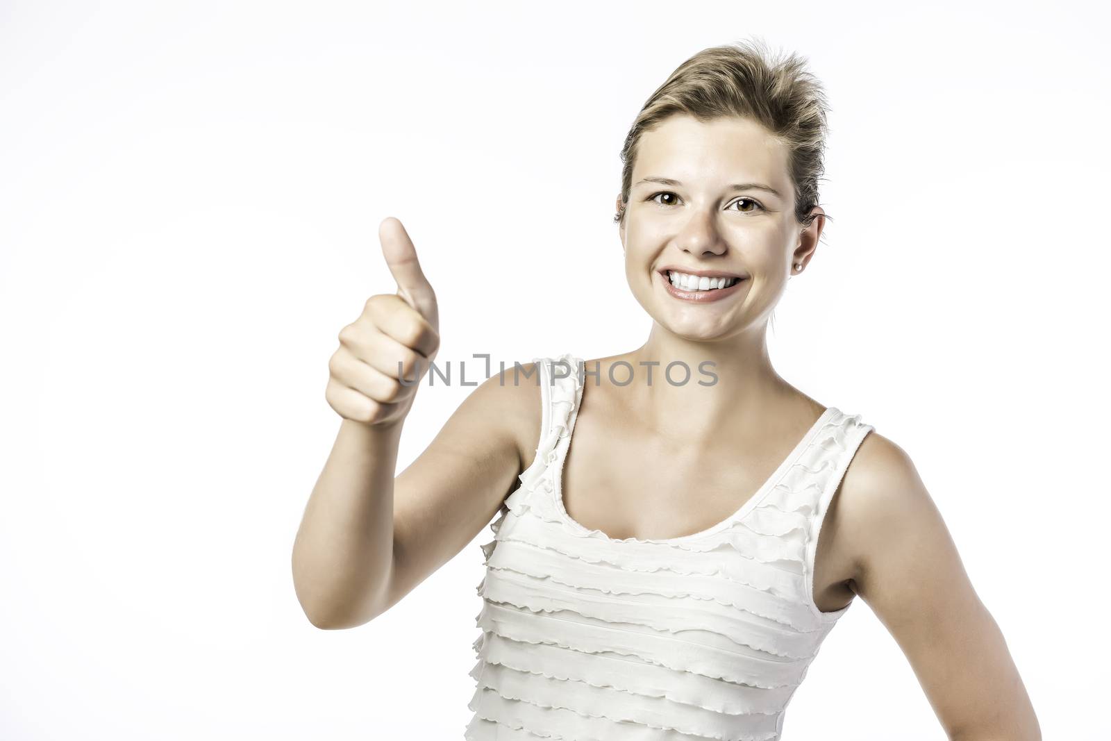 Laughing, young beautiful woman holds her thumb up, isolated on white background