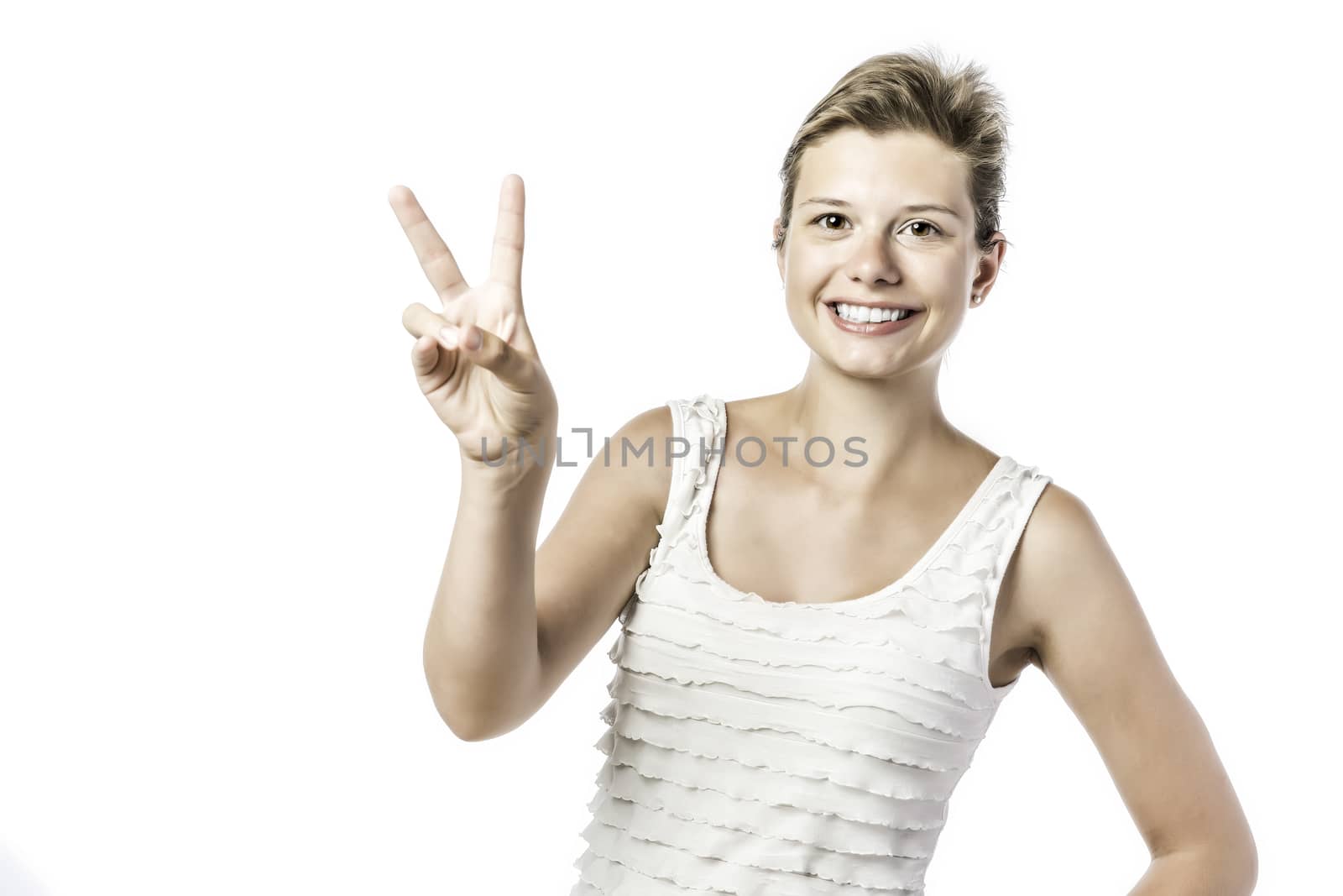 Laughing, young beautiful woman makes the victory sign, isolated on white background