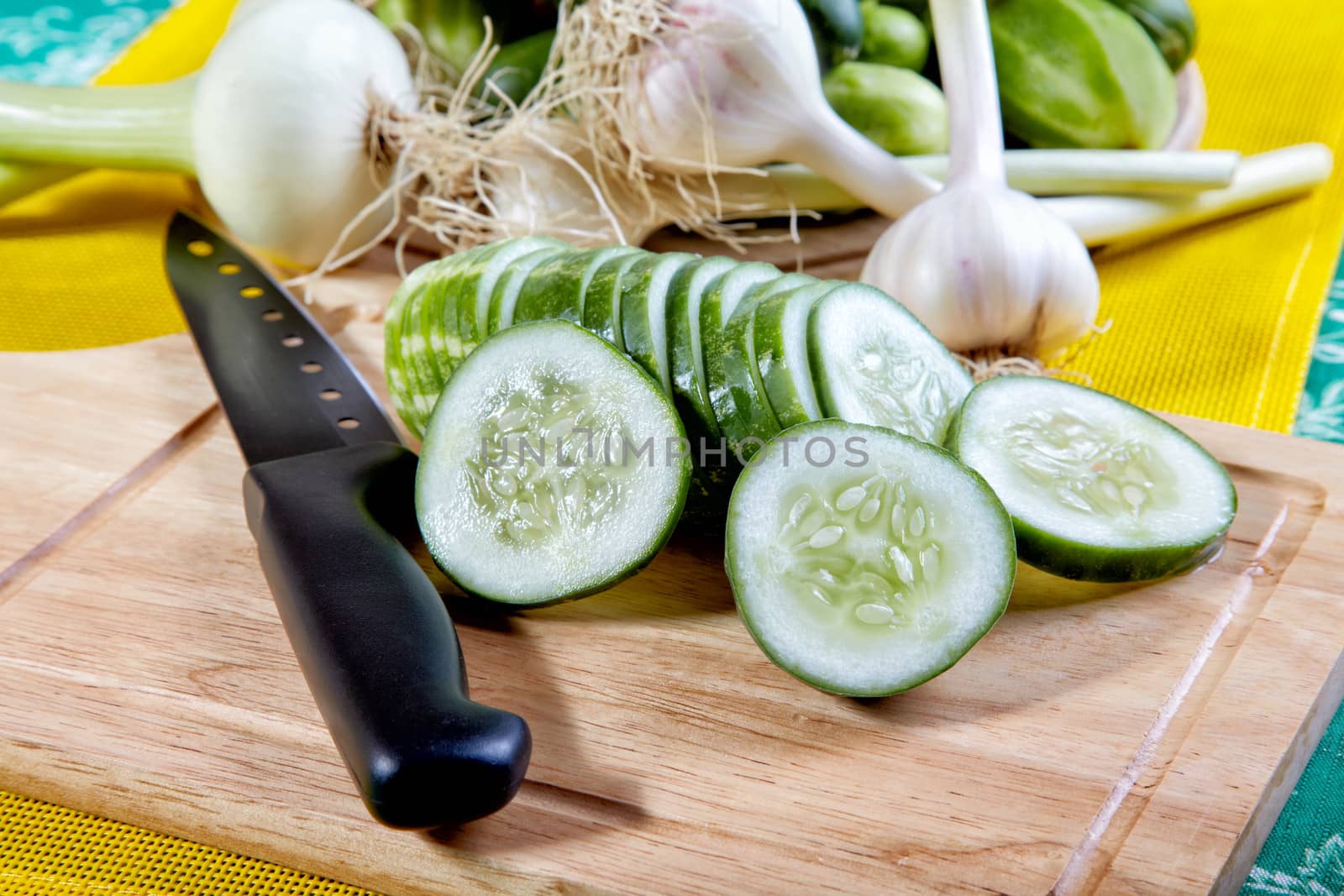 Still-life with the cut cucumbers an onions and garlic