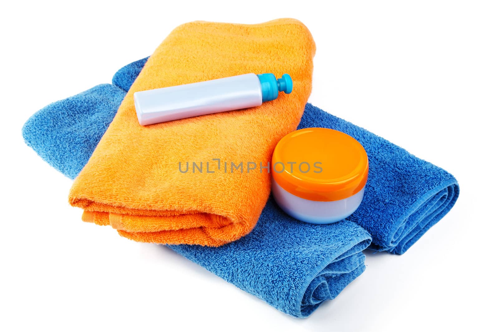 Still-life with bath towel and shampoo on a white background