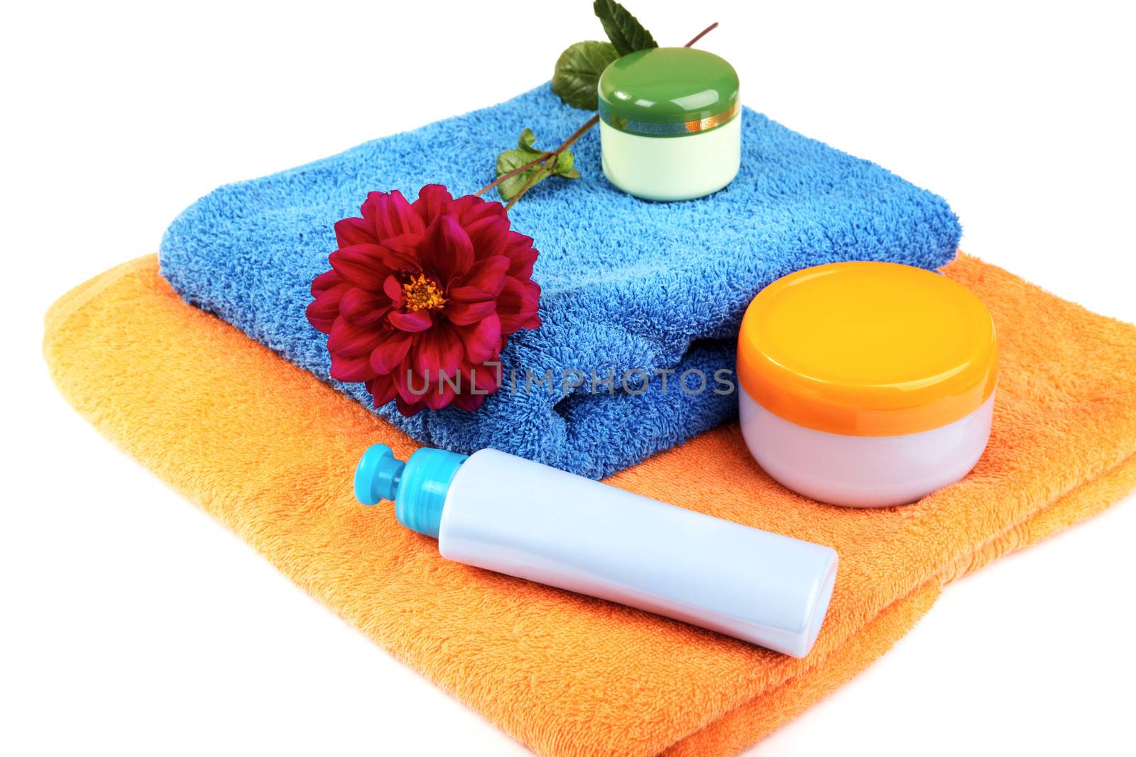 Still-life with bath towel  shampoo and a flower