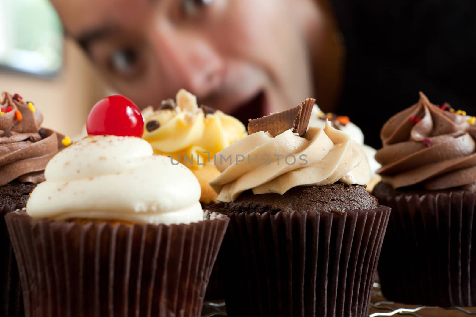 Man Looks At Cupcakes by graficallyminded