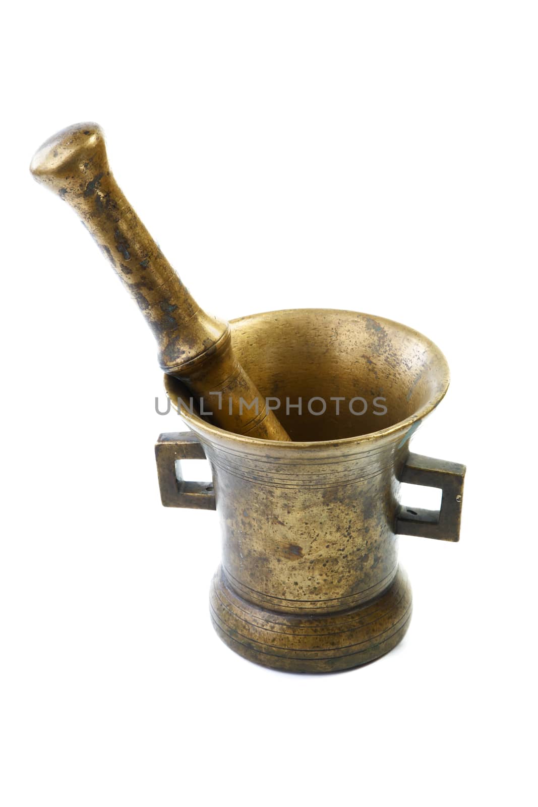 Brass mortar with a pestle isolated on a white background