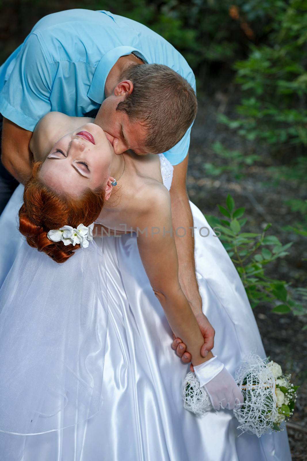 Passionate Wedding Kiss in a Summer City Park