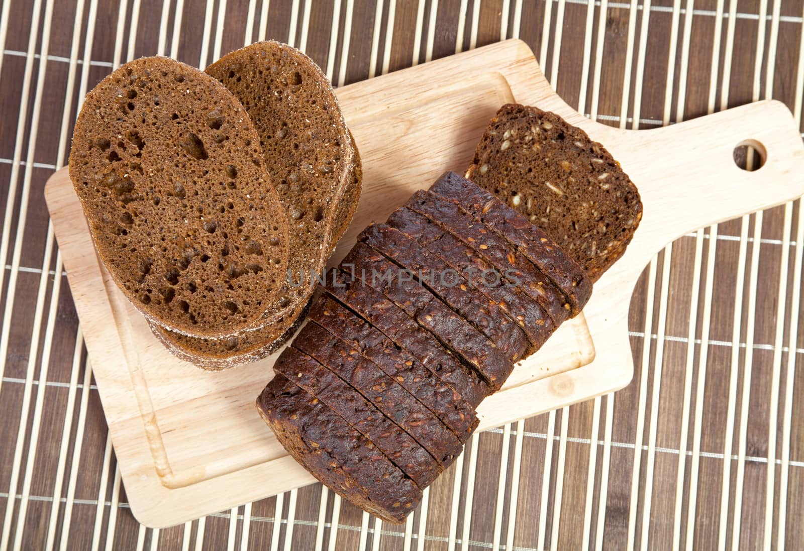 Slices cut black bread  on a chopping board