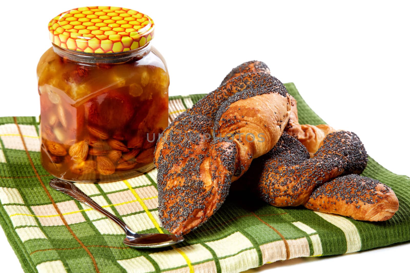 Bank of honey and roll with a poppy on  white background