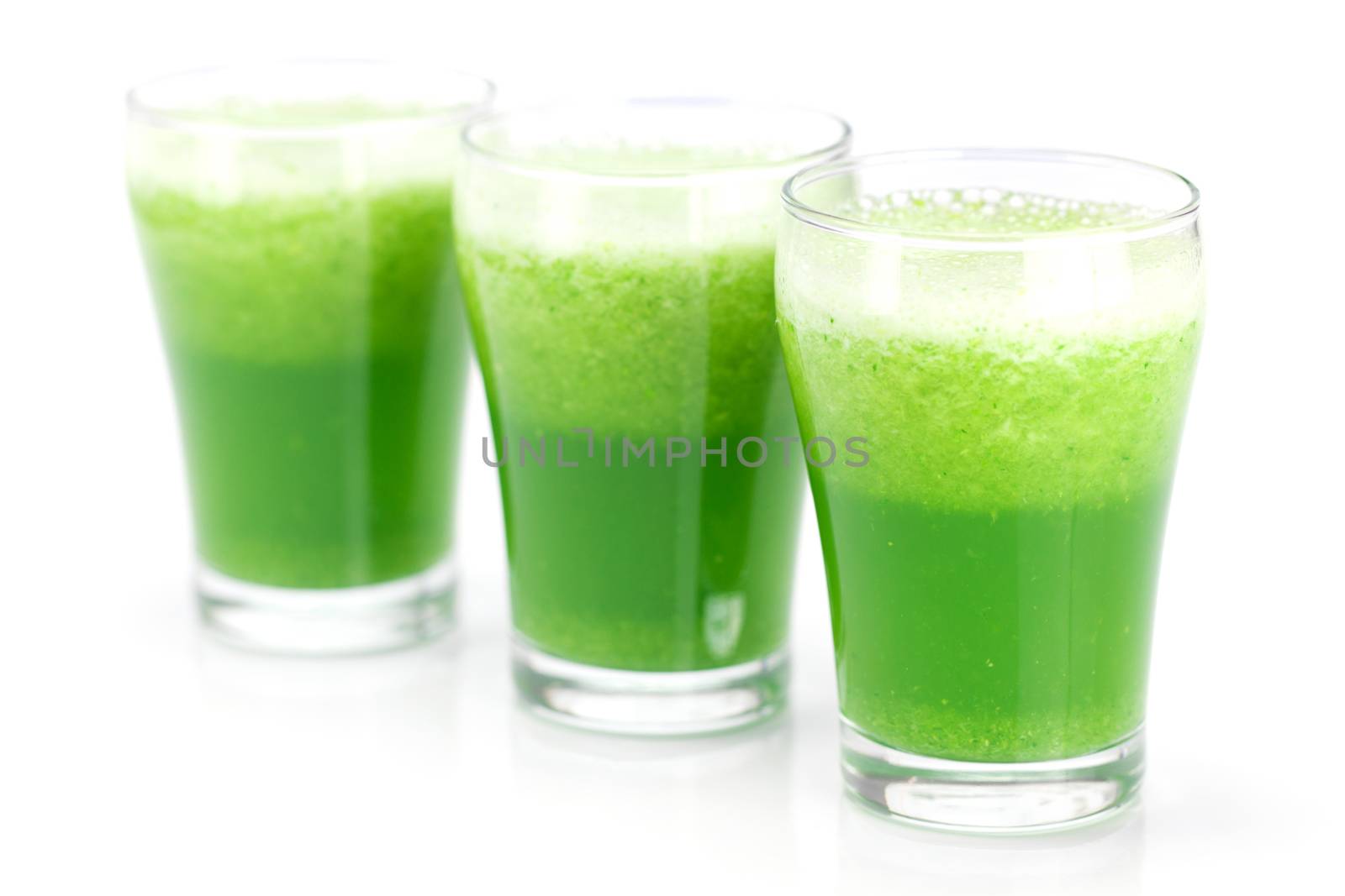 three glasses with celery juice isolated on white