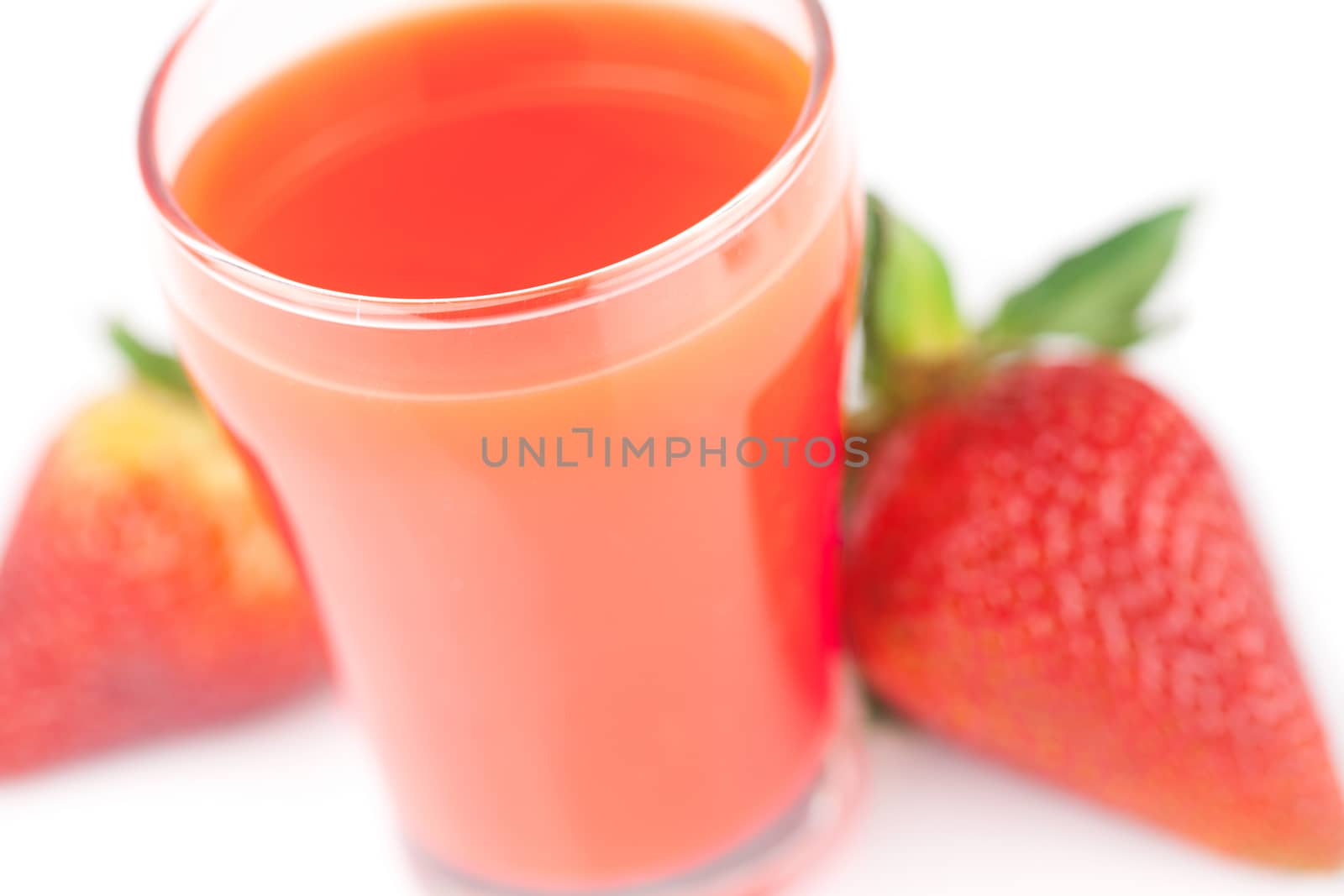 strawberry and a glass of strawberry juice isolated on white
