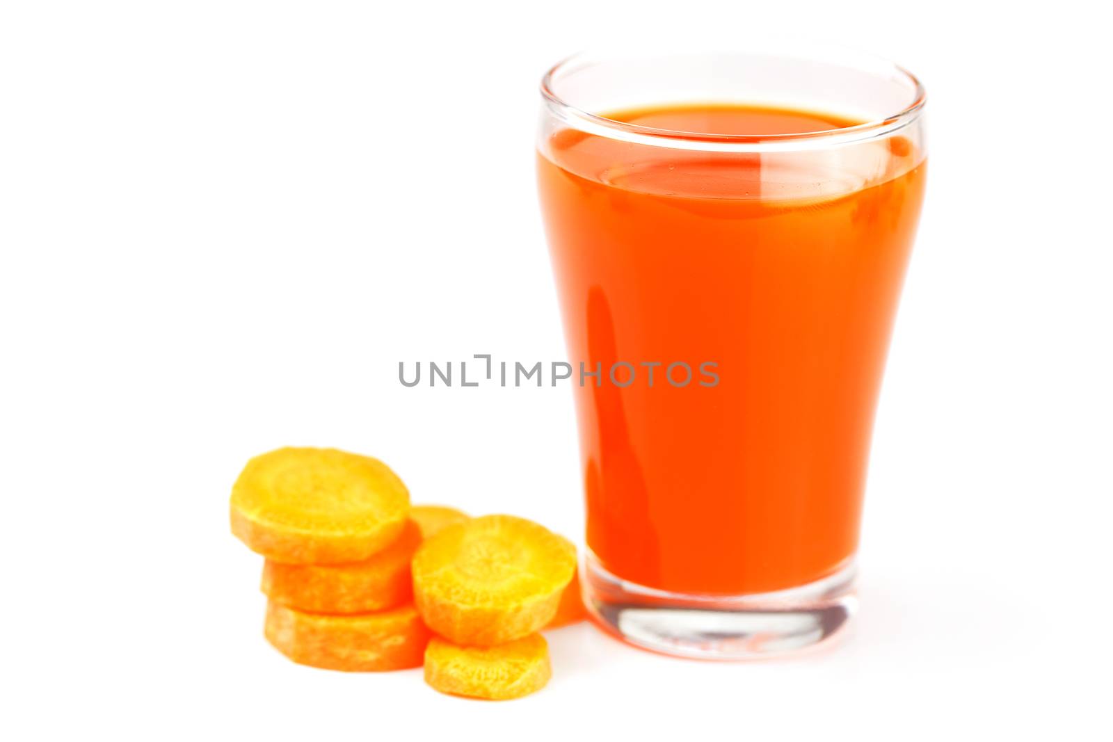carrot and a glass of carrot juice isolated on white