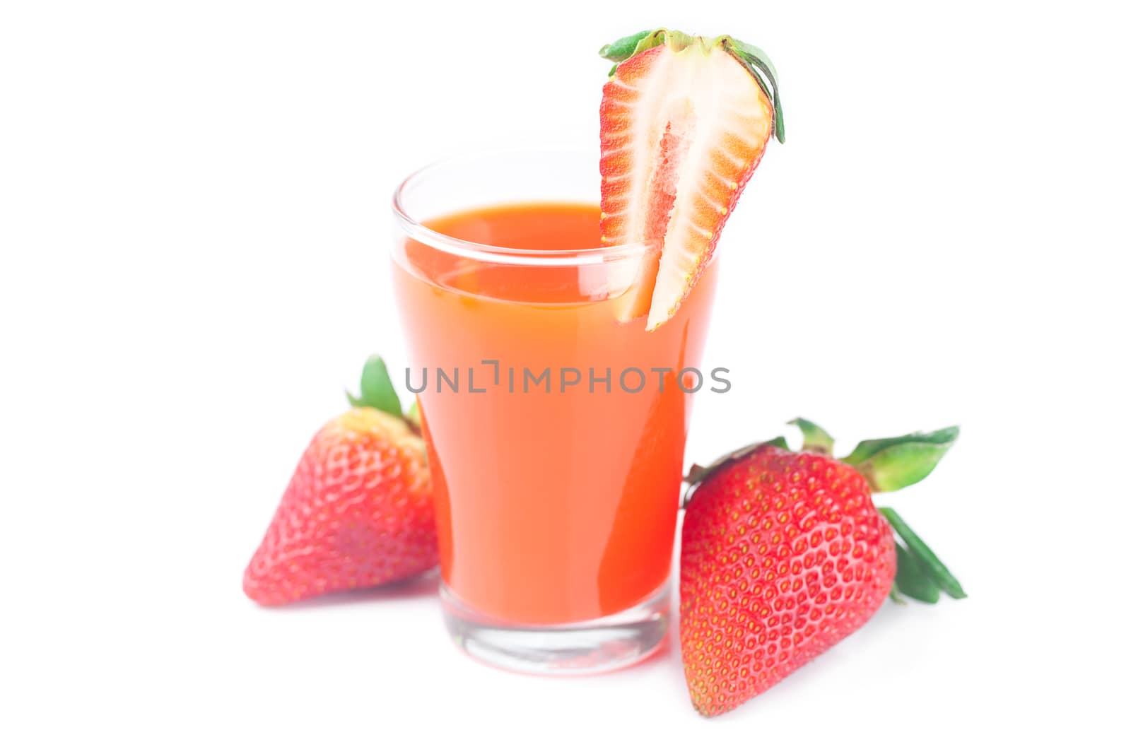 strawberry and a glass of strawberry juice isolated on white