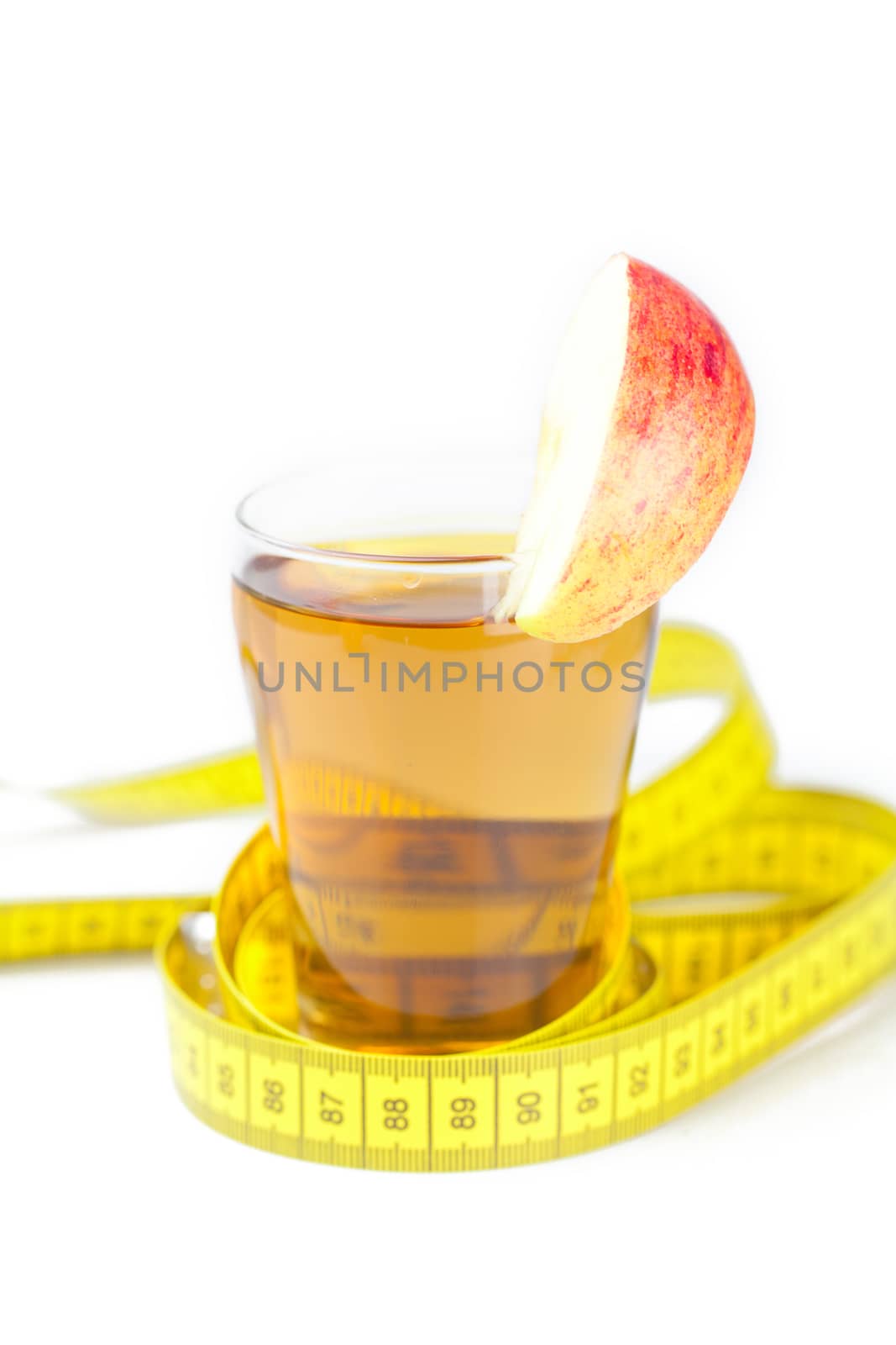 measuring tape,apples and glass of apple juice isolated on white