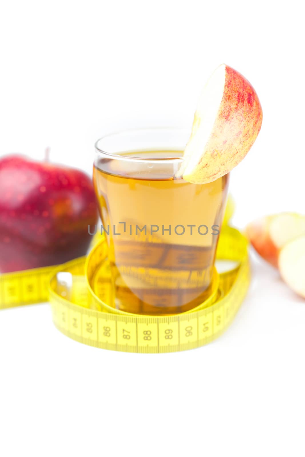 measuring tape,apples and glass of apple juice isolated on white by jannyjus