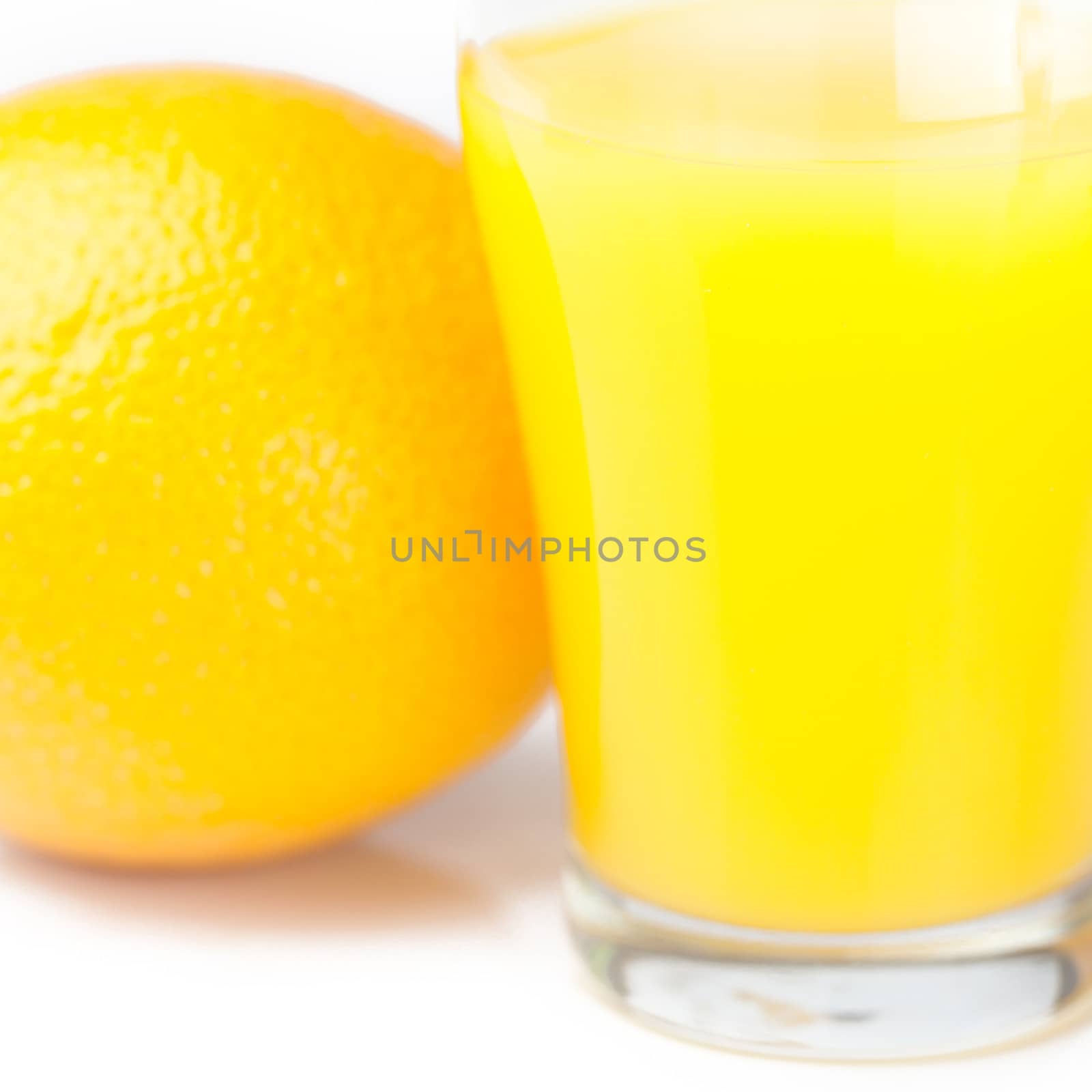 orange and a glass of orange juice isolated on white