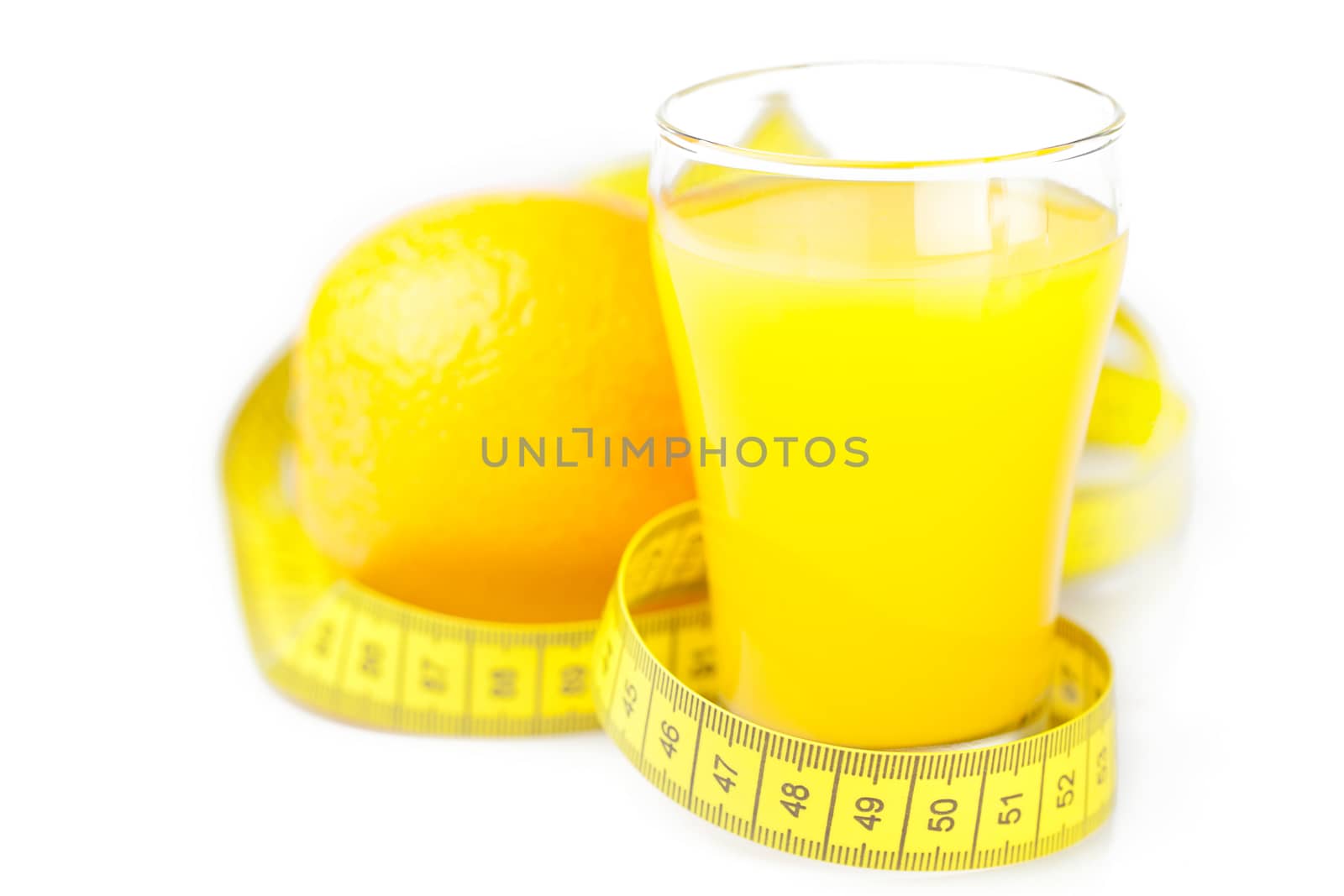 measuring tape,orange and a glass of orange juice isolated on wh by jannyjus